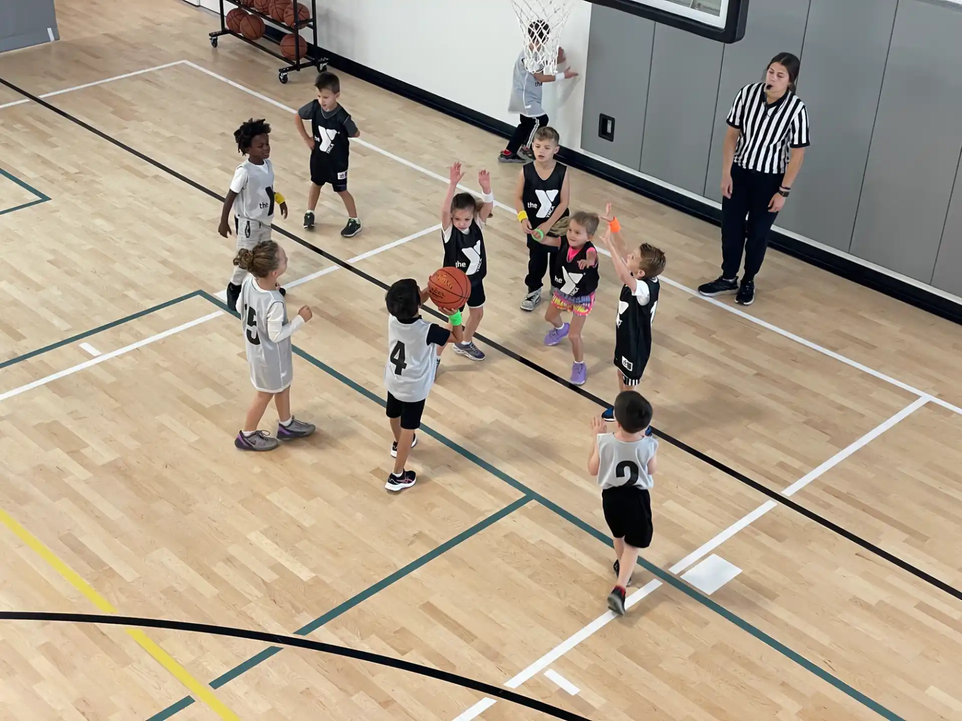 a group of people playing basketball