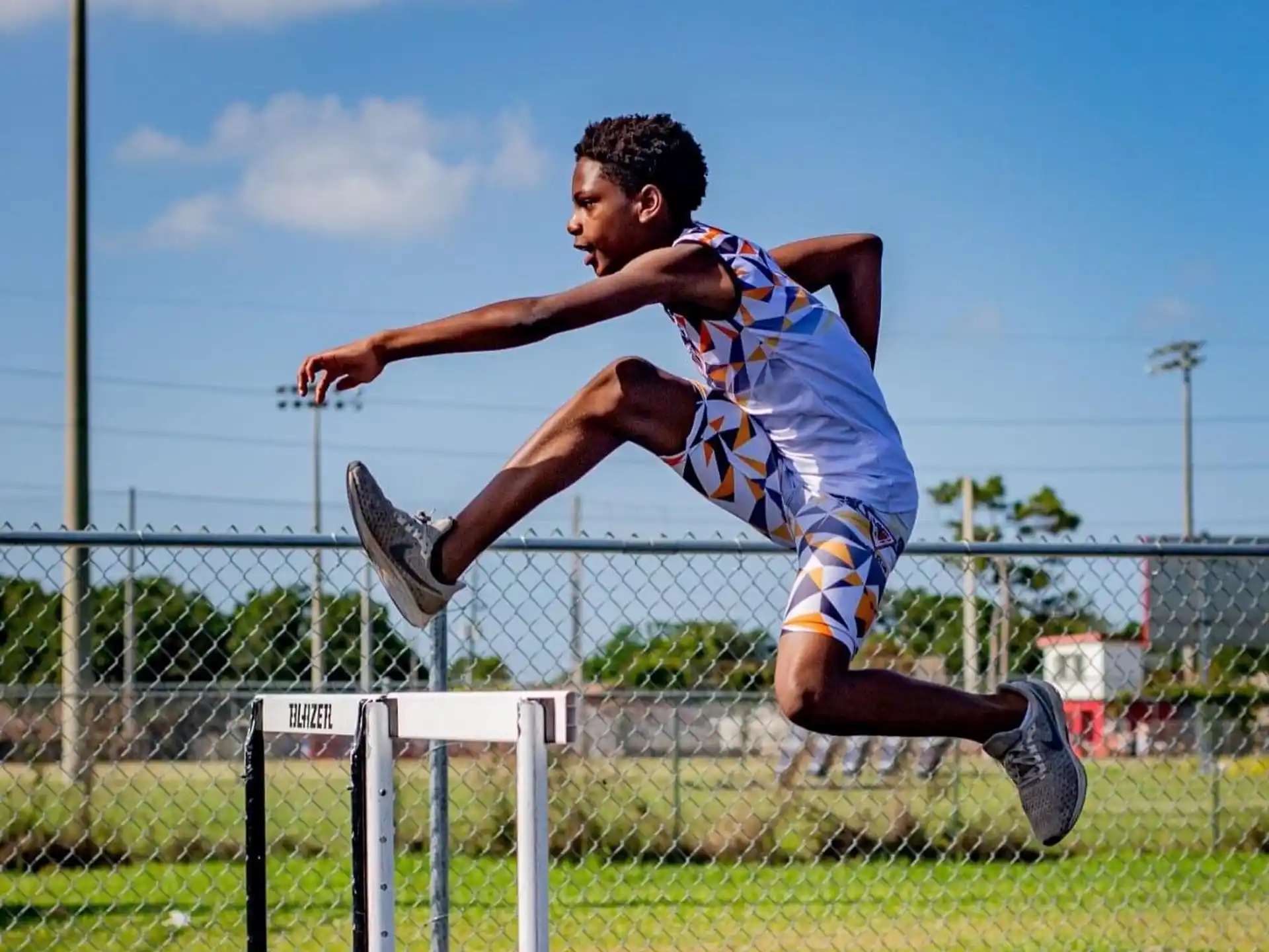 a man jumping over a hurdle