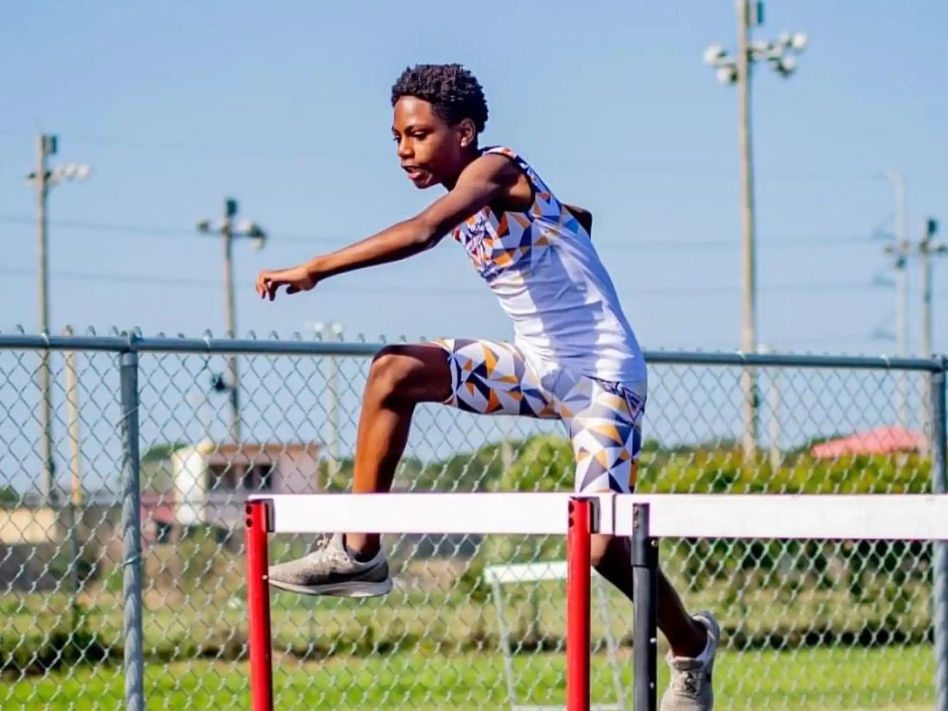 a person jumping over a fence
