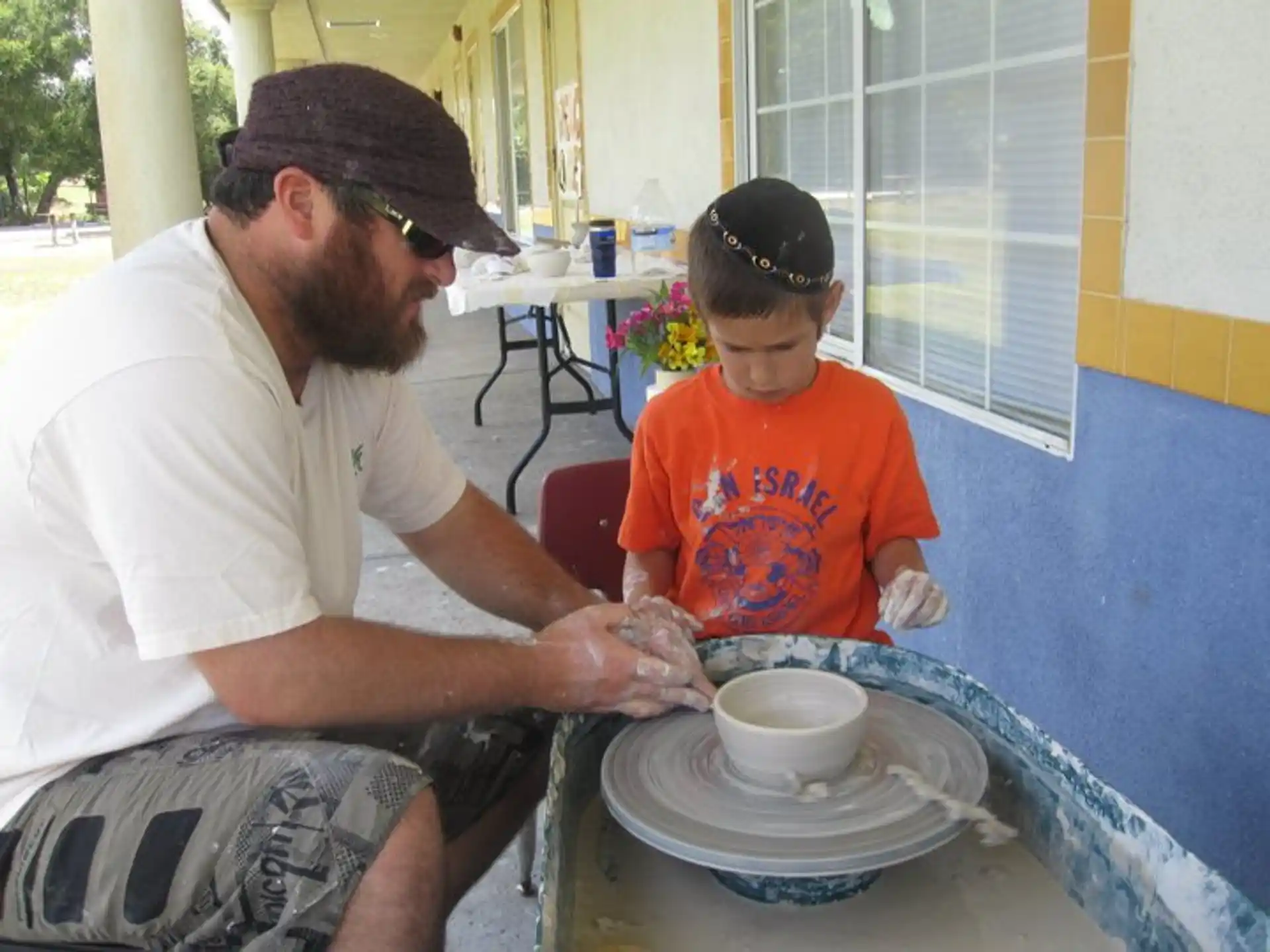 a man and a boy sitting outside
