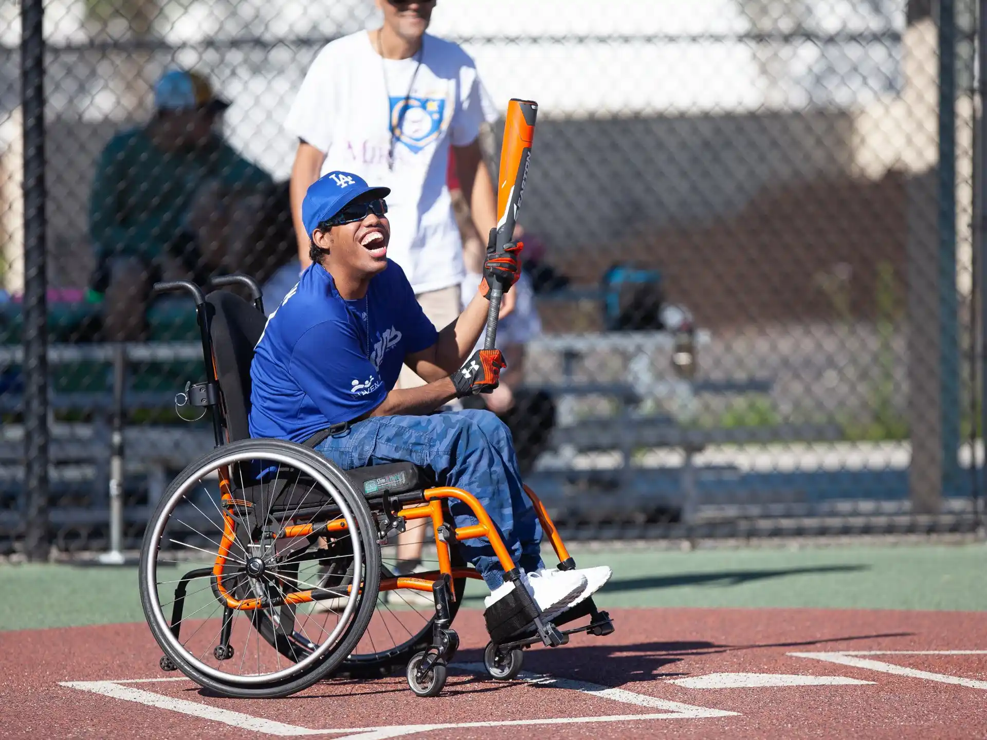 a person in a wheelchair holding a baseball bat