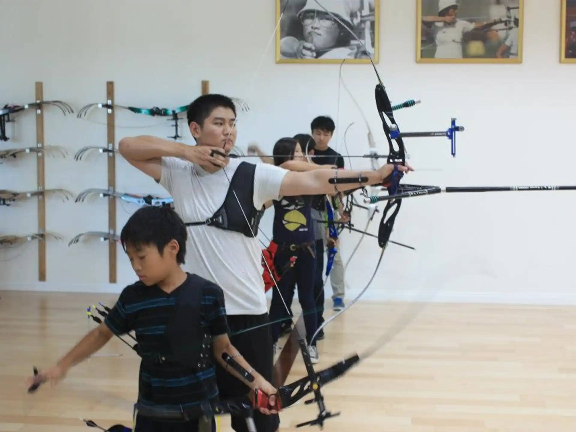 a group of people holding bows and arrows