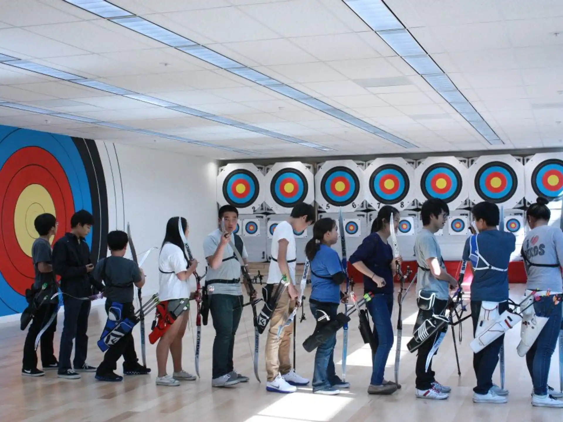 a group of people standing in front of a wall with logos