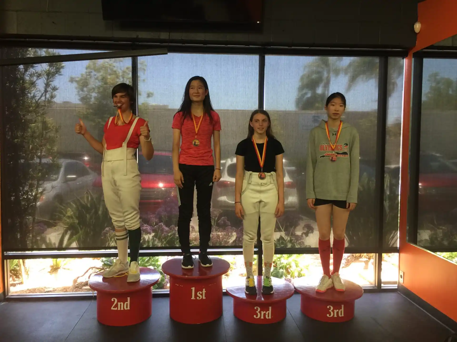 a group of women standing on red and white platforms
