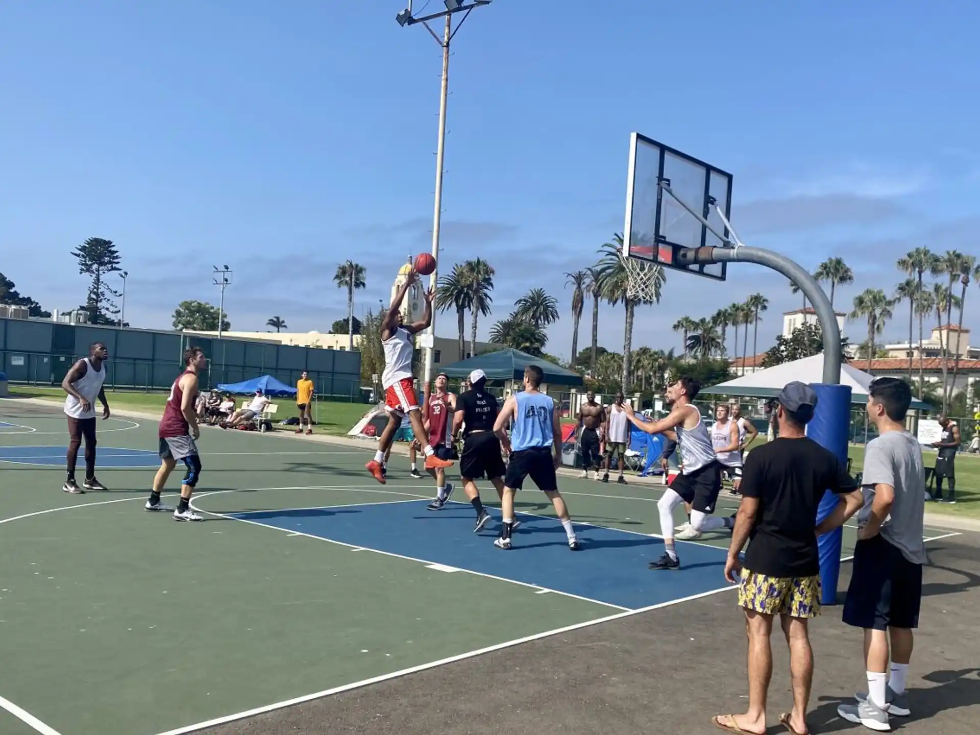 a group of people playing basketball