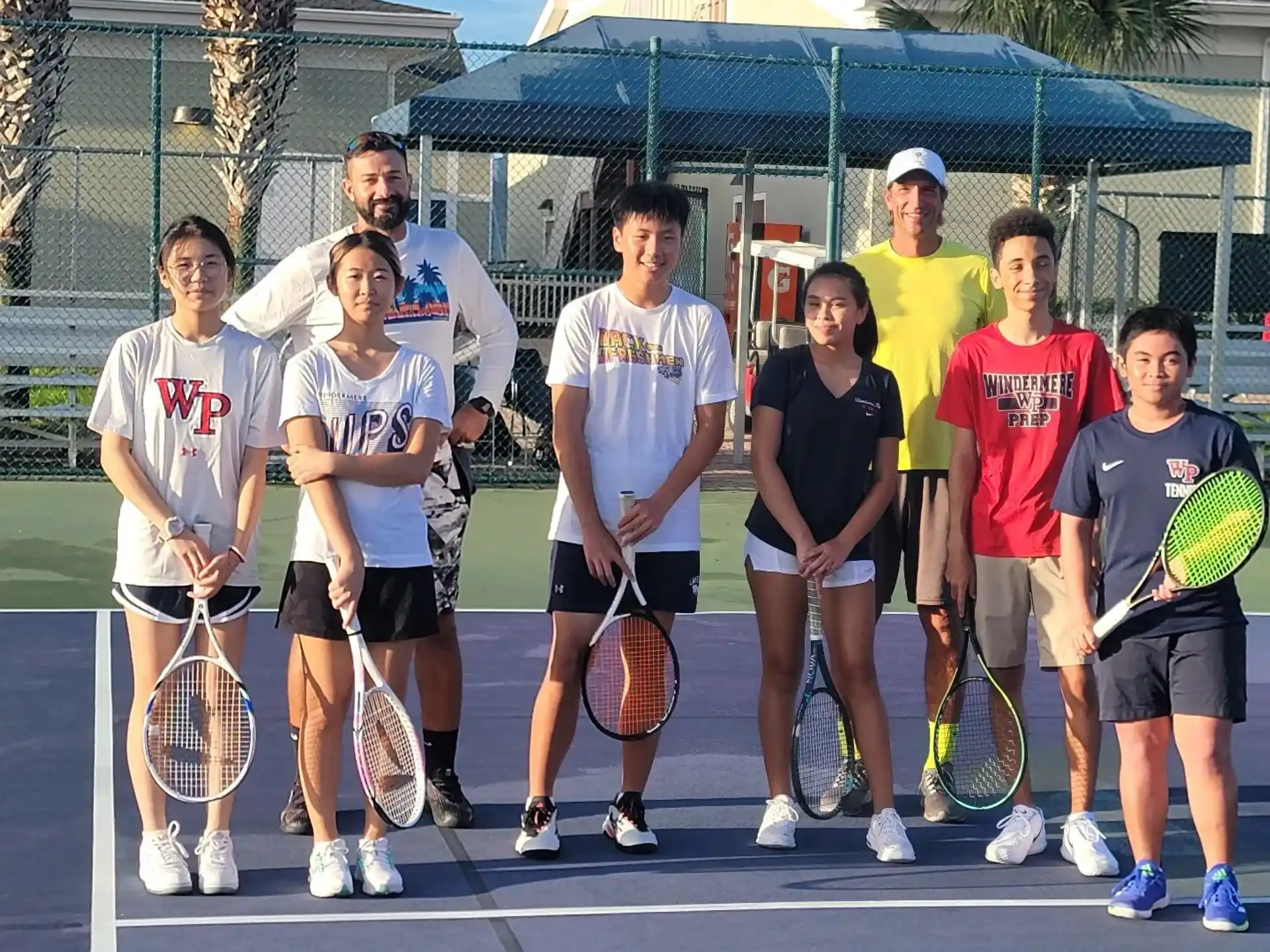 a group of people holding tennis rackets