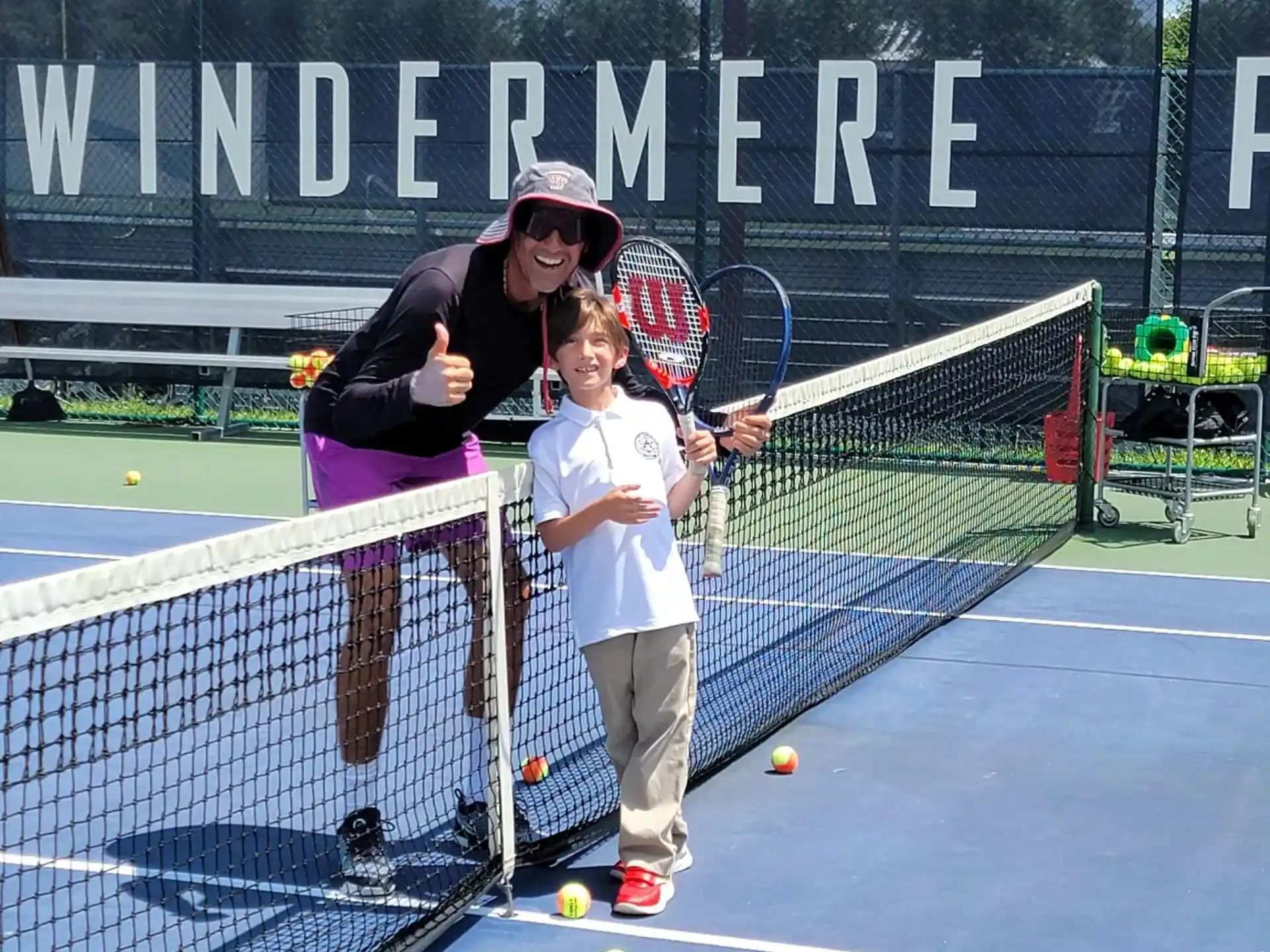 a man and a boy playing tennis
