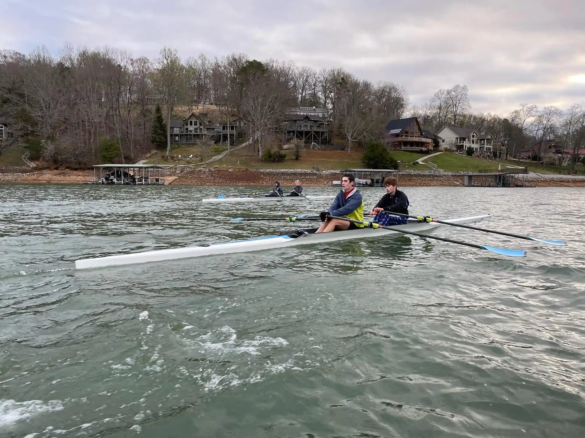 a couple of people rowing a boat