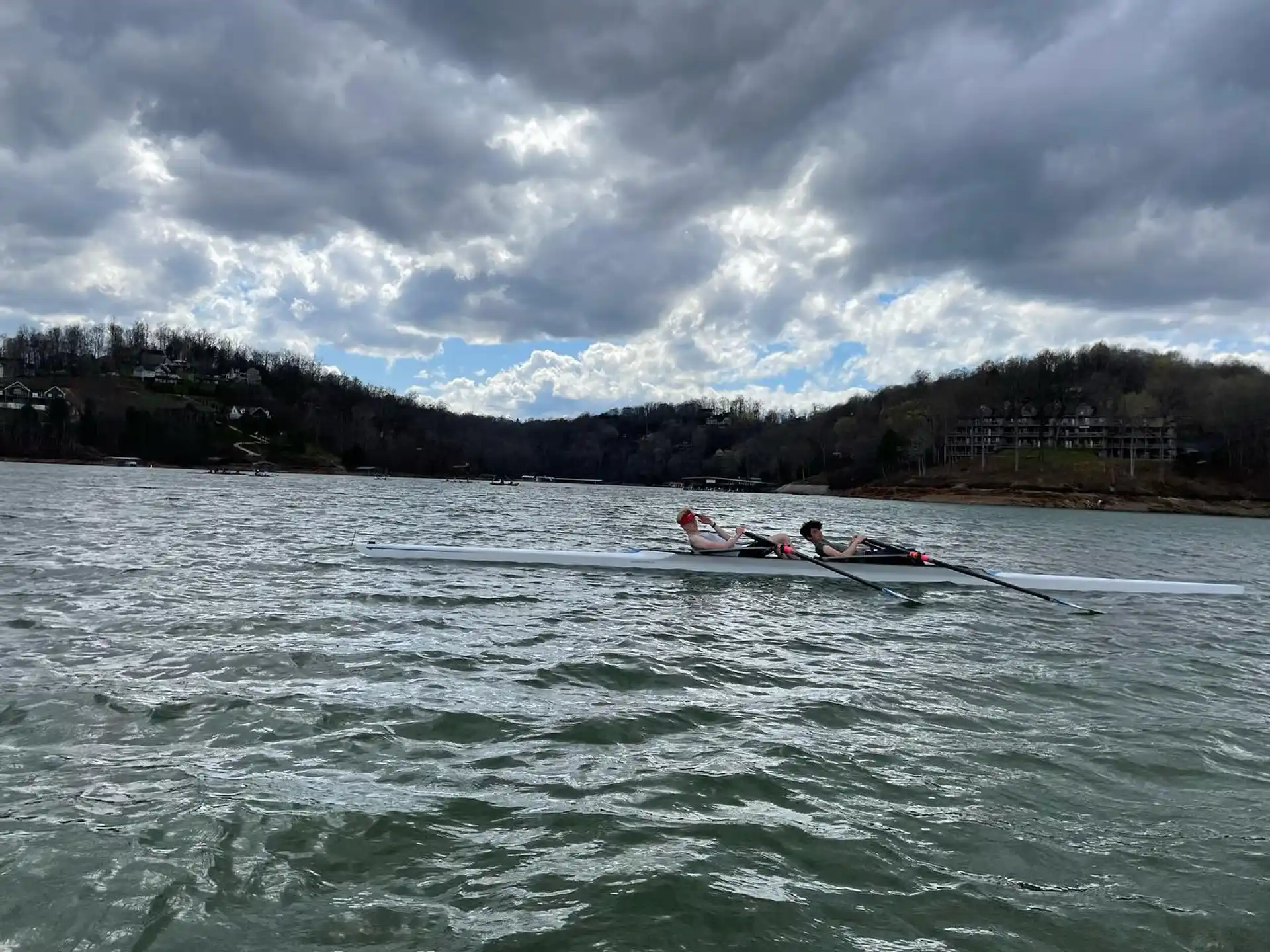 a group of people rowing a boat