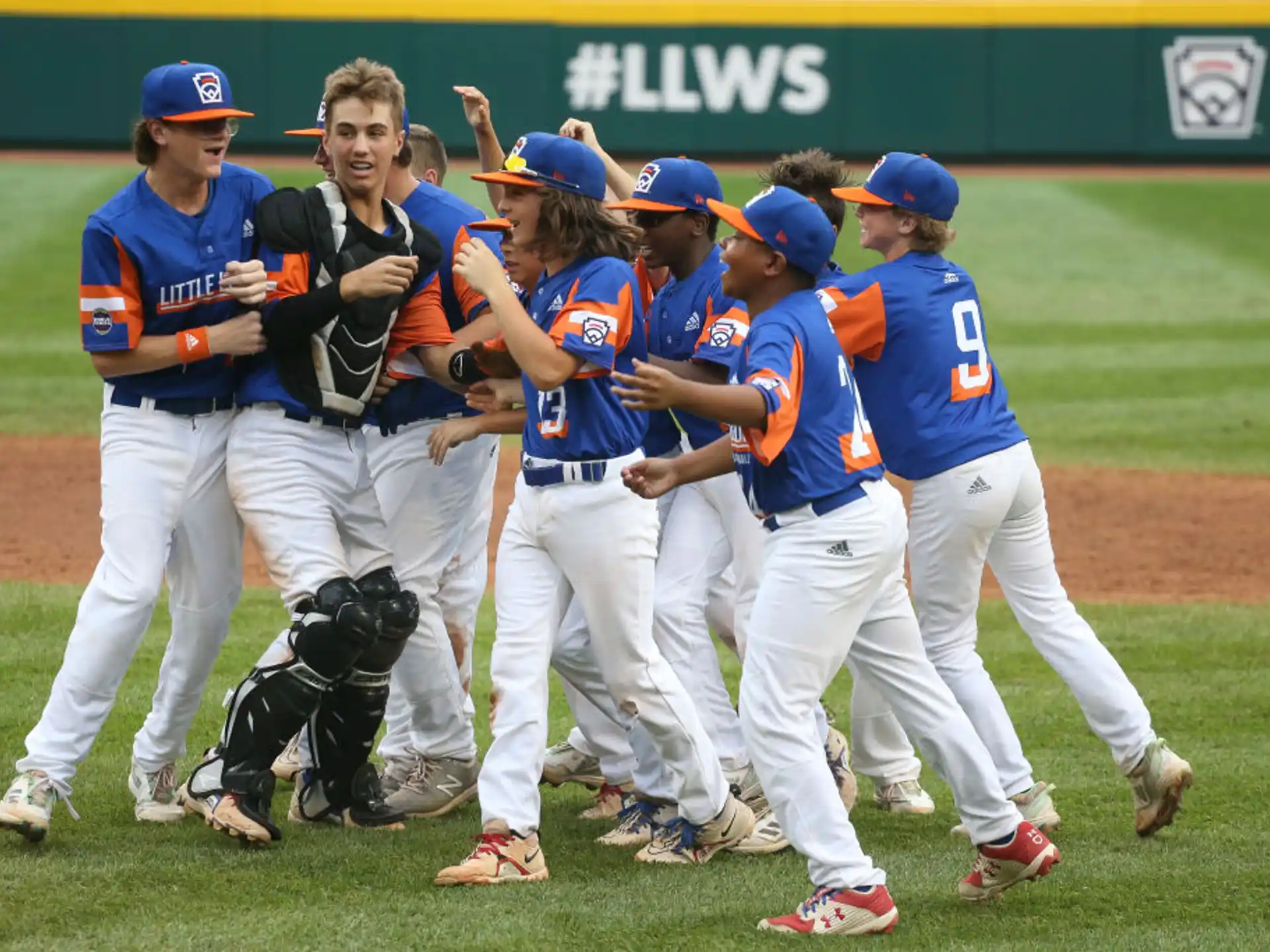 a group of baseball players walking on a field