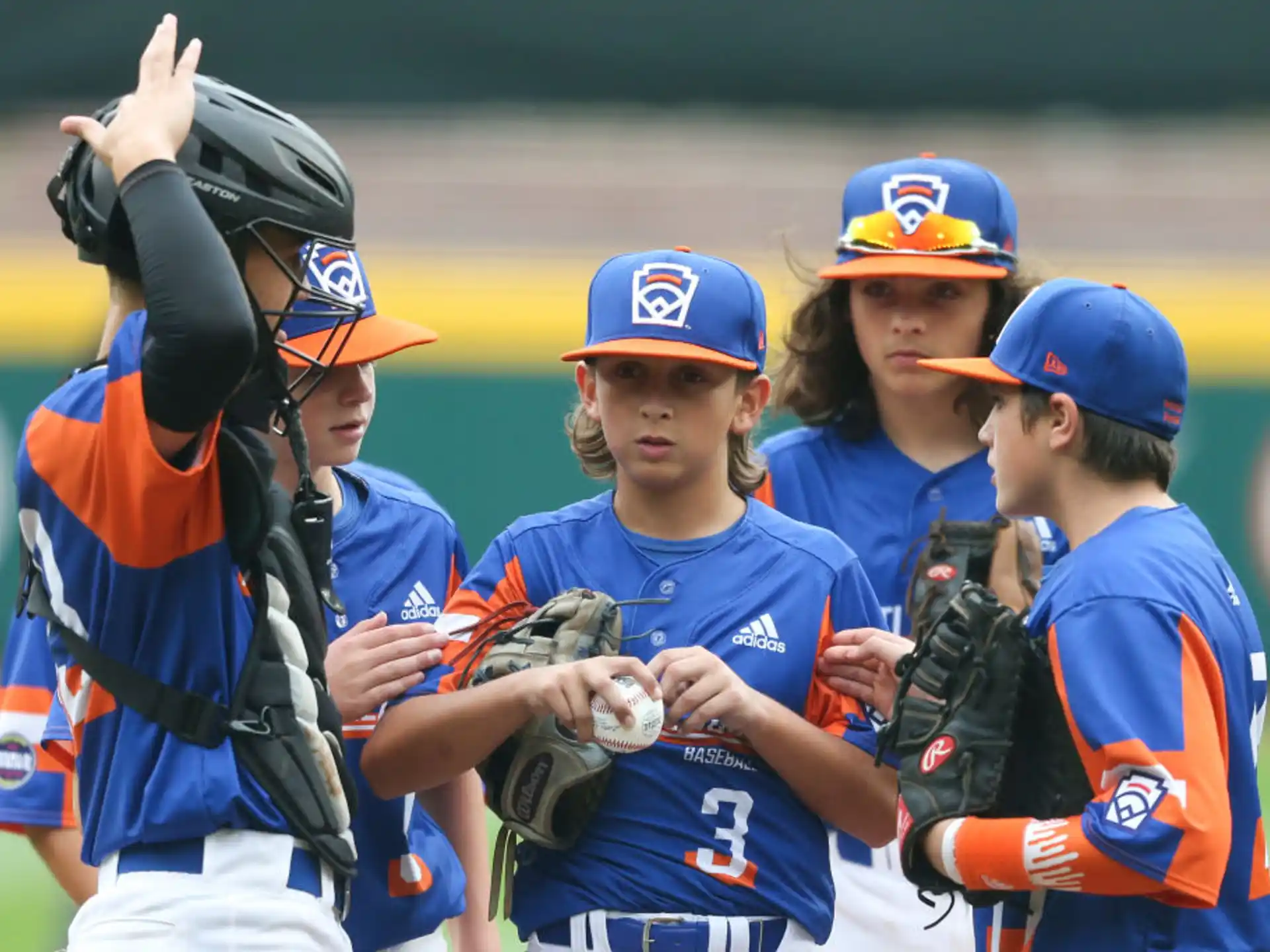 a group of kids in baseball uniforms