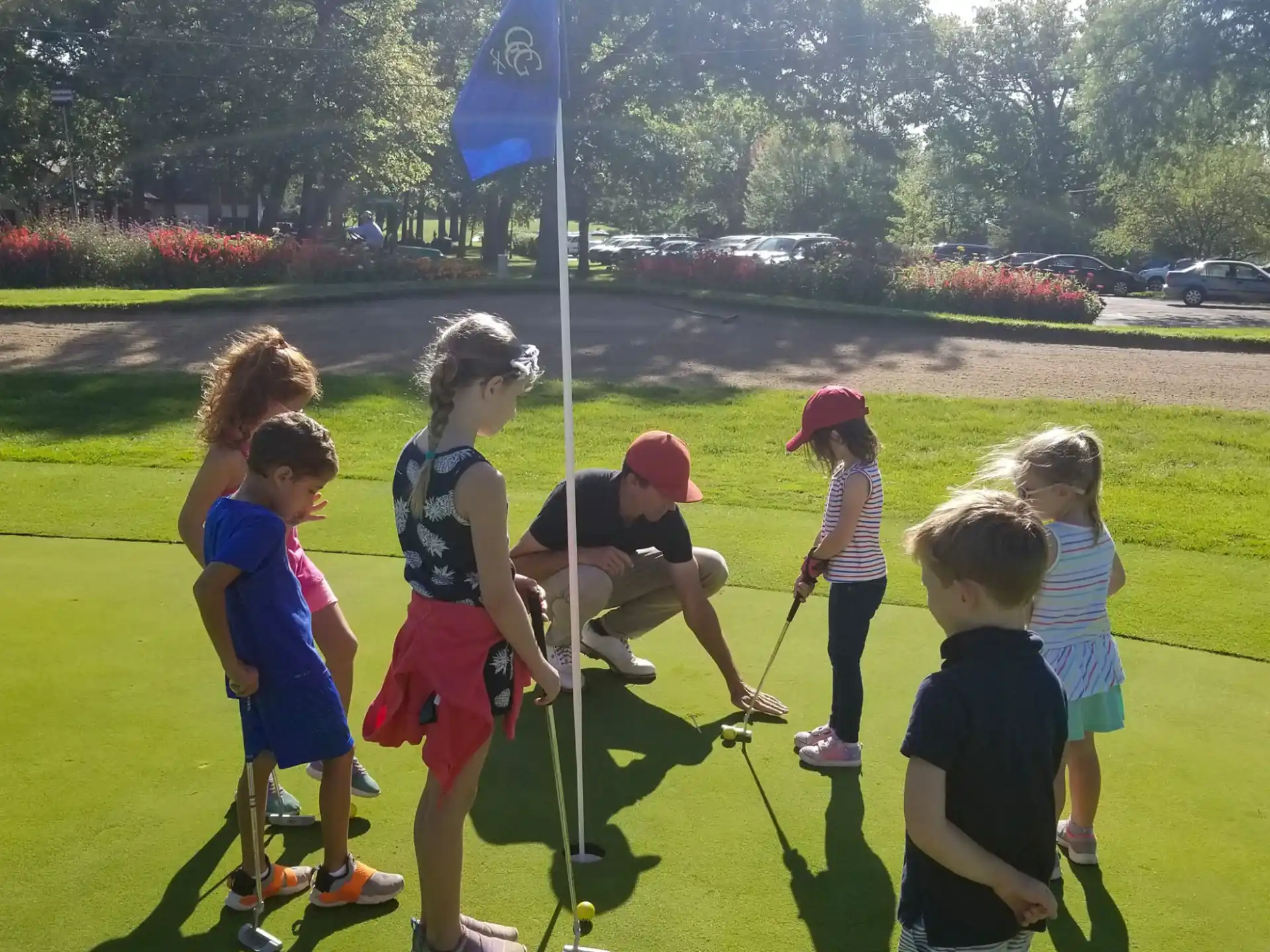 a group of children playing in a grassy area