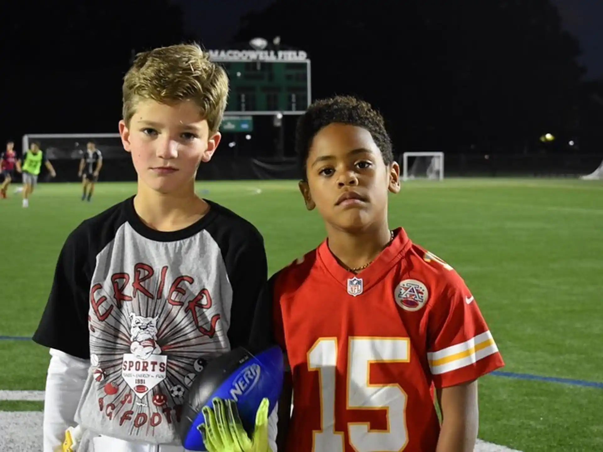 two boys in sports uniforms