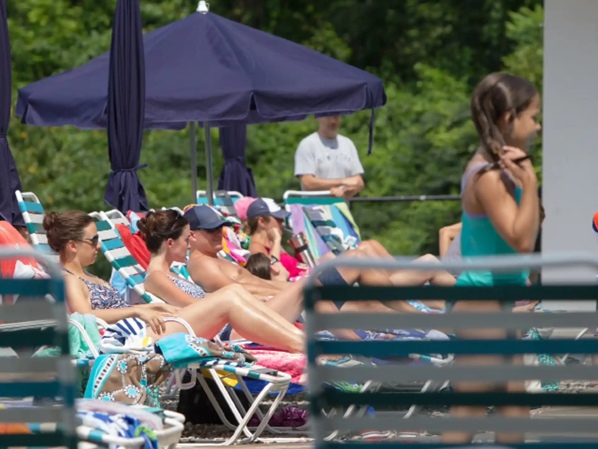 a group of people sitting on beach chairs