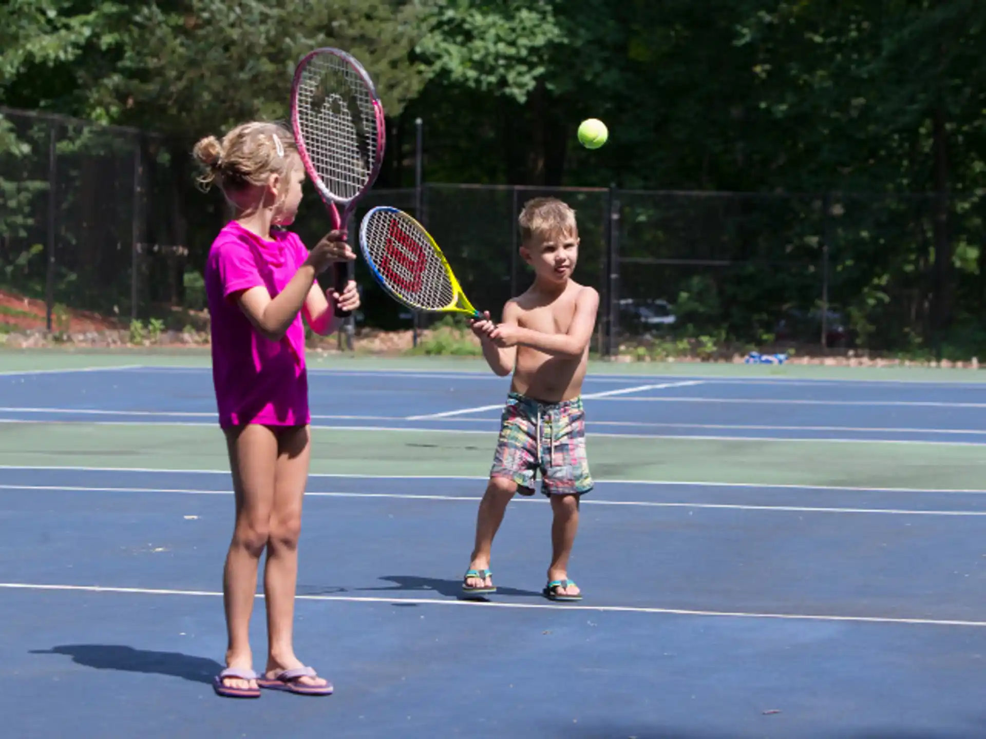 kids playing tennis on court