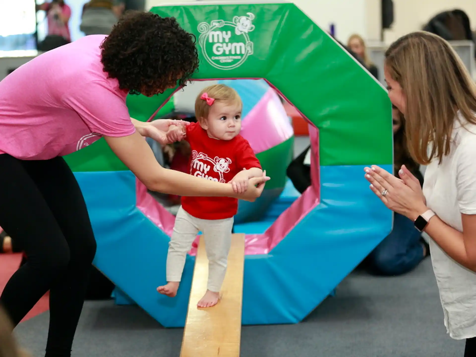 a woman and a child playing in a large ball