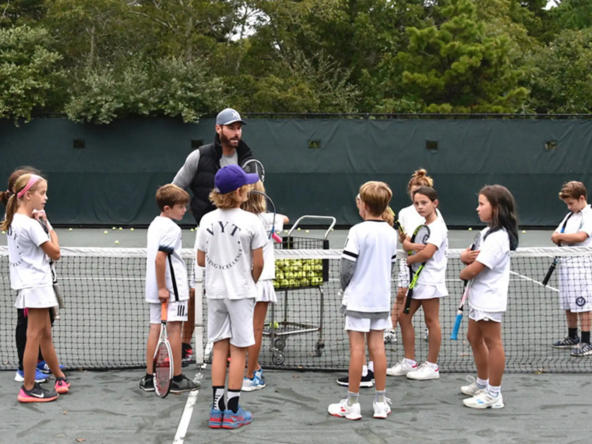 a group of girls holding tennis rackets