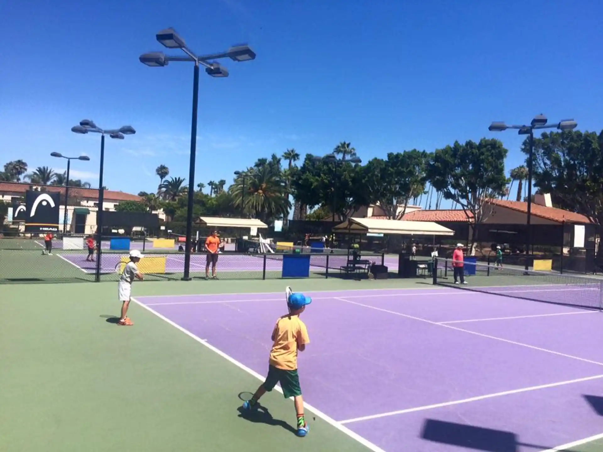 a group of people play tennis