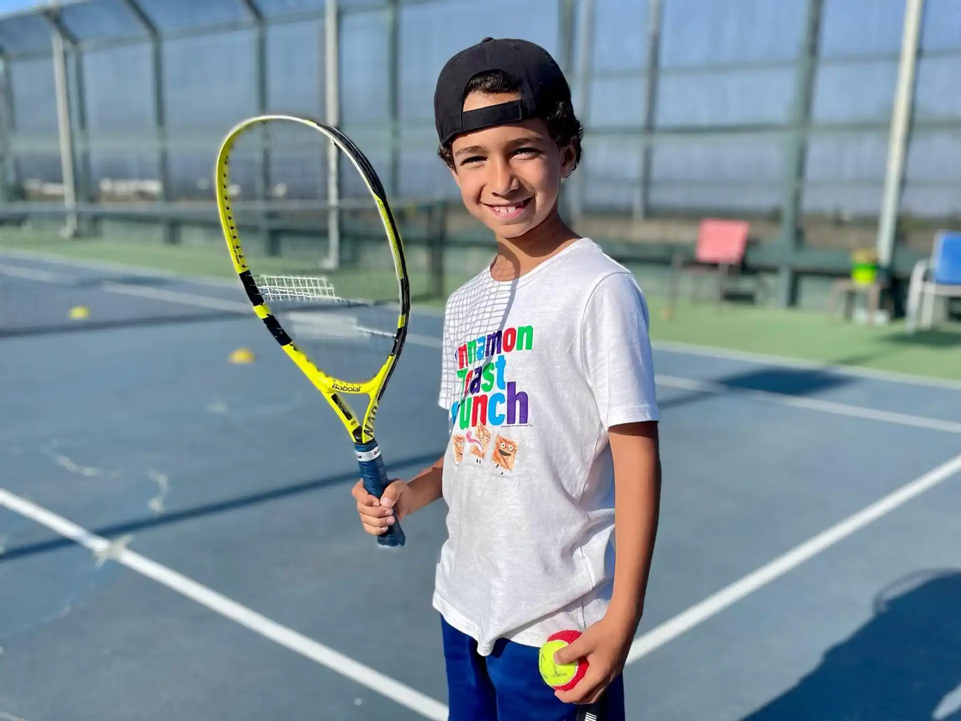 a girl holding a tennis racket