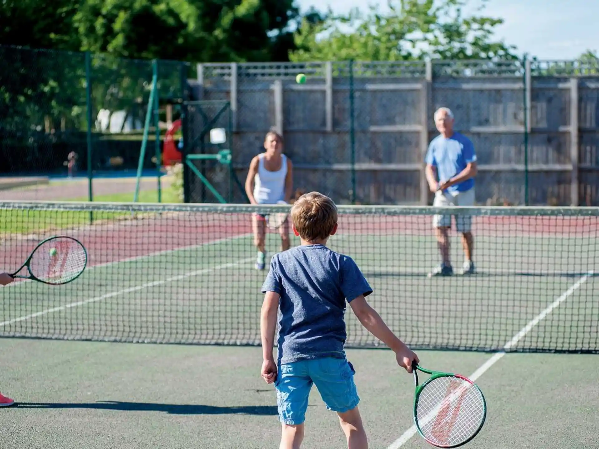 a kid playing tennis