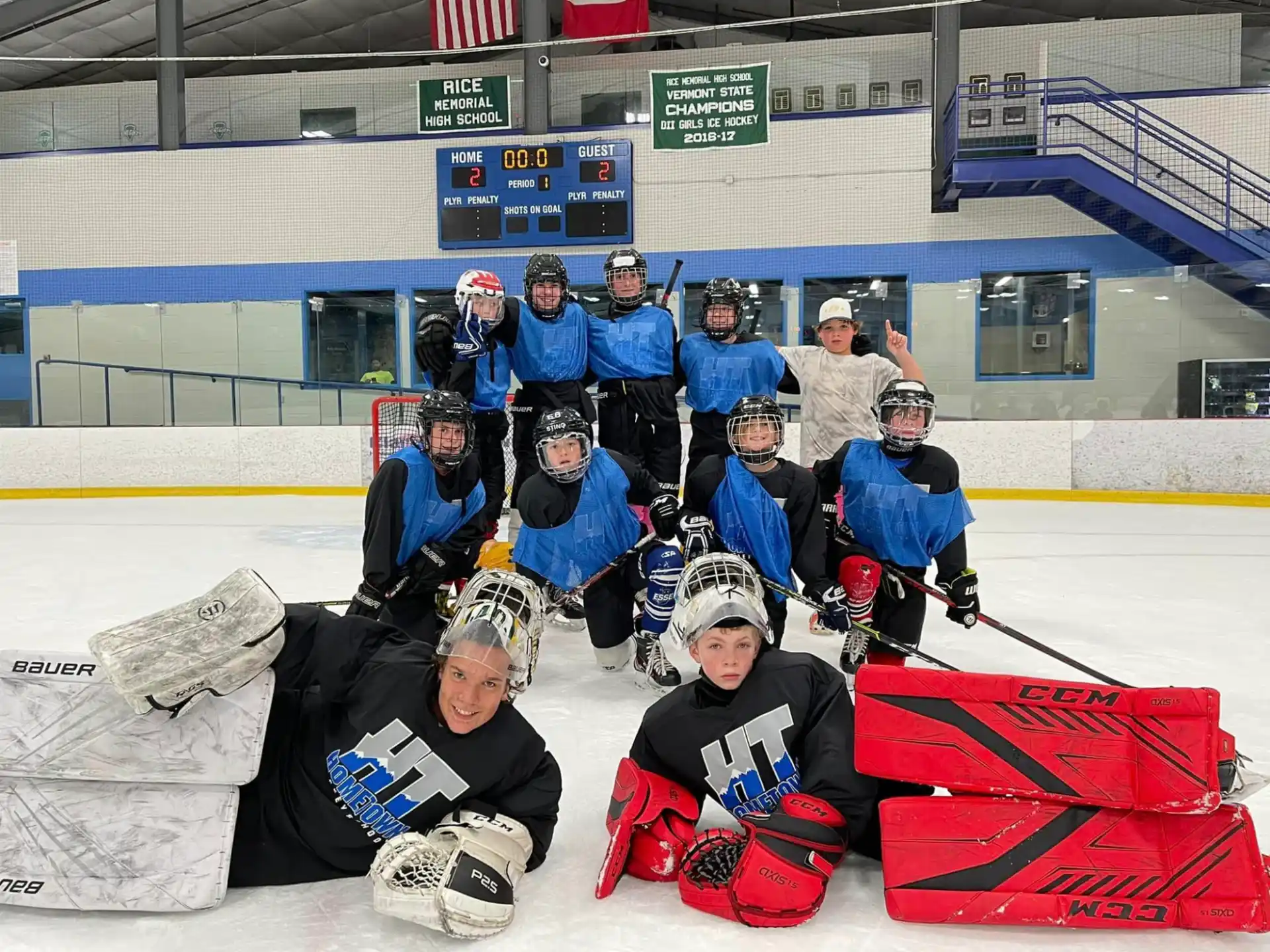 a group of people posing for a photo on a hockey rink