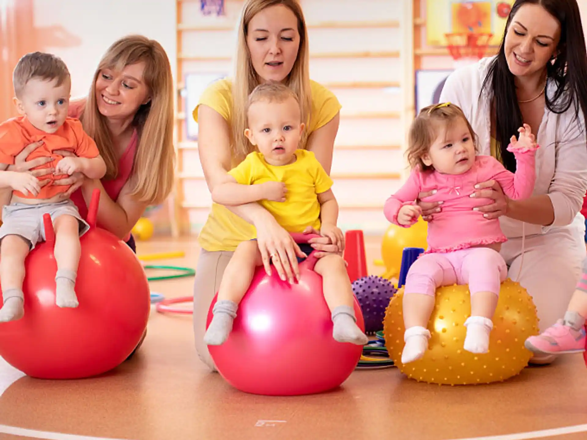 a group of children sitting on balls