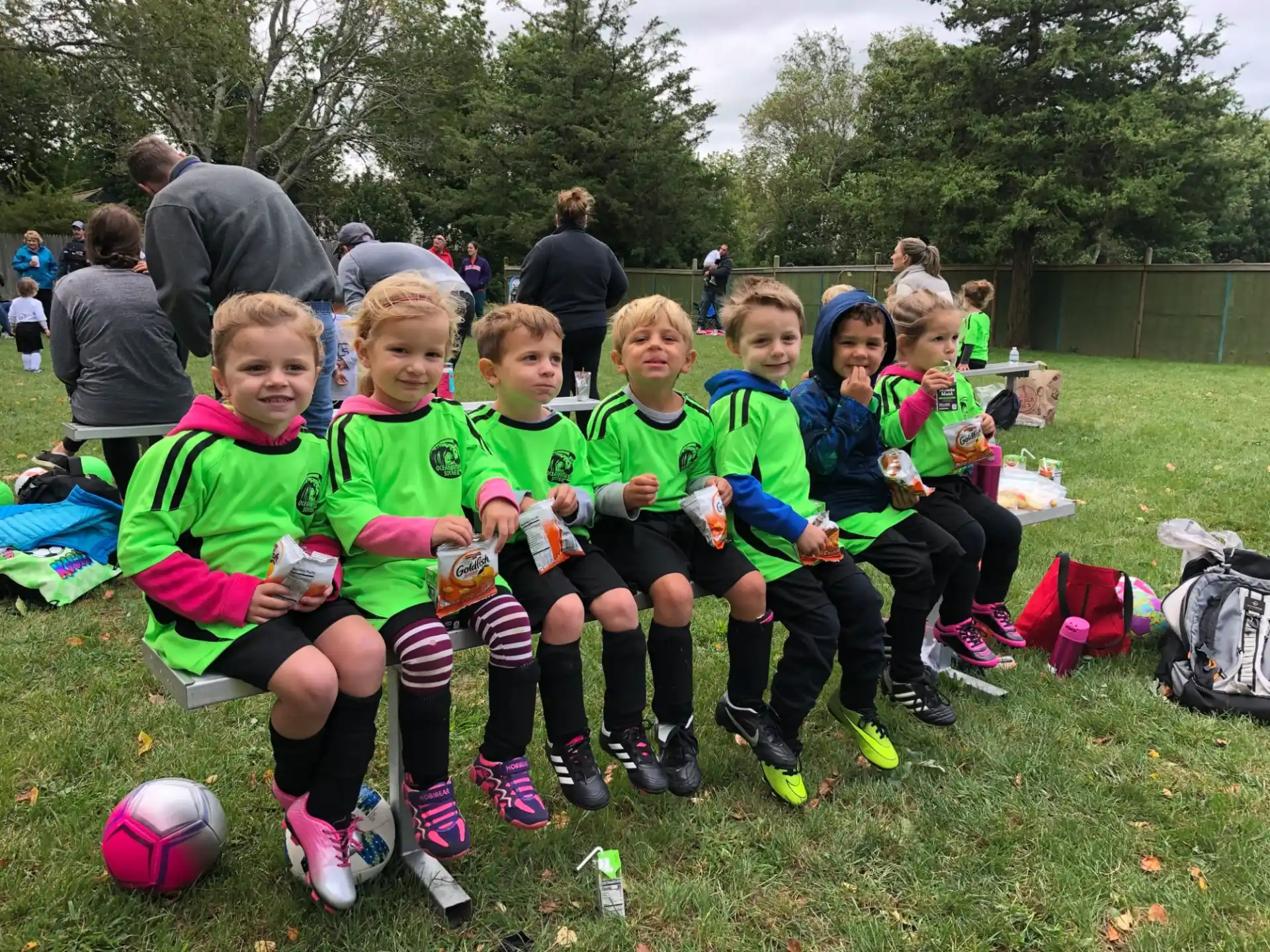 a group of children in football uniforms
