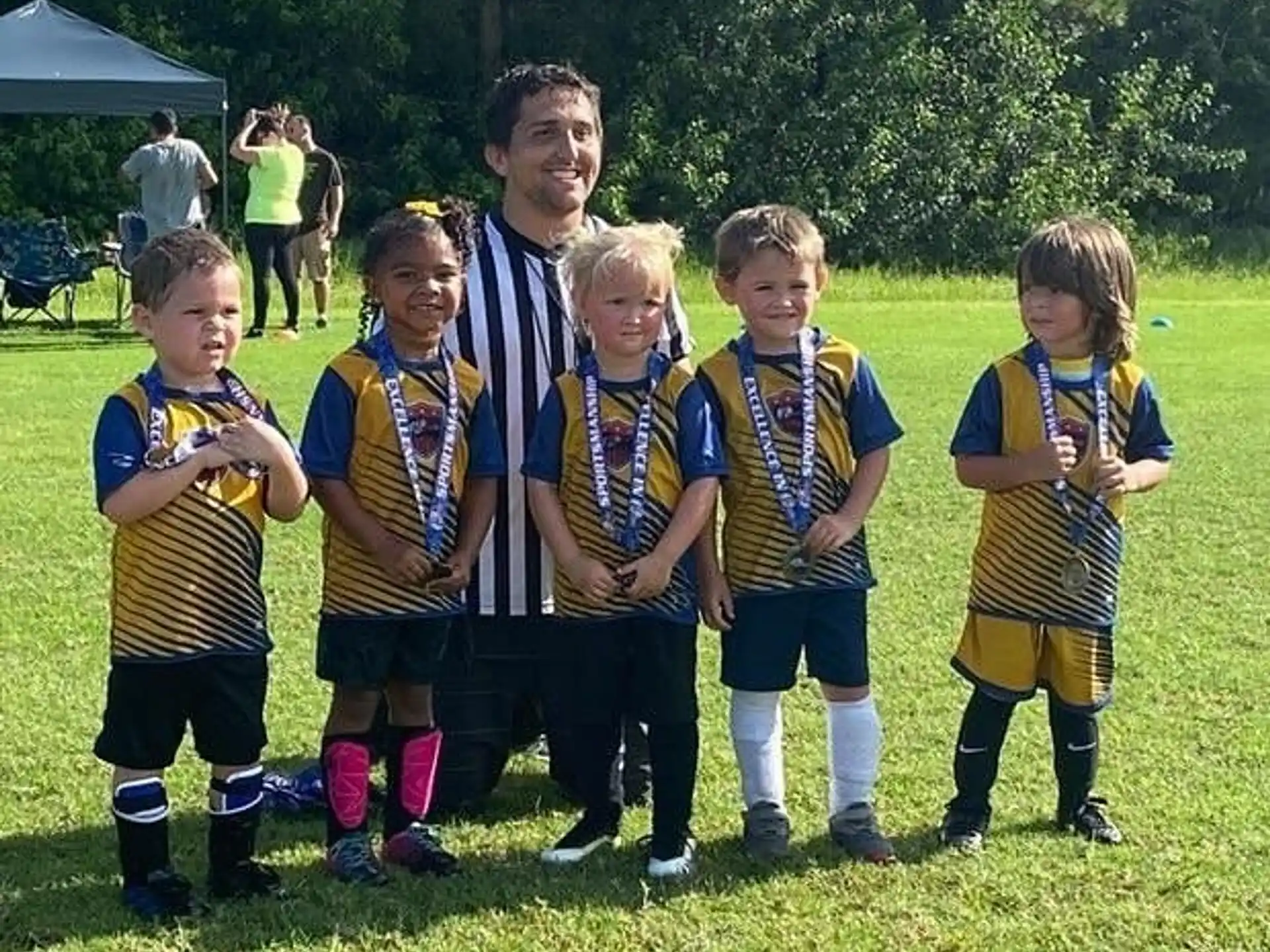 a group of kids in football uniforms