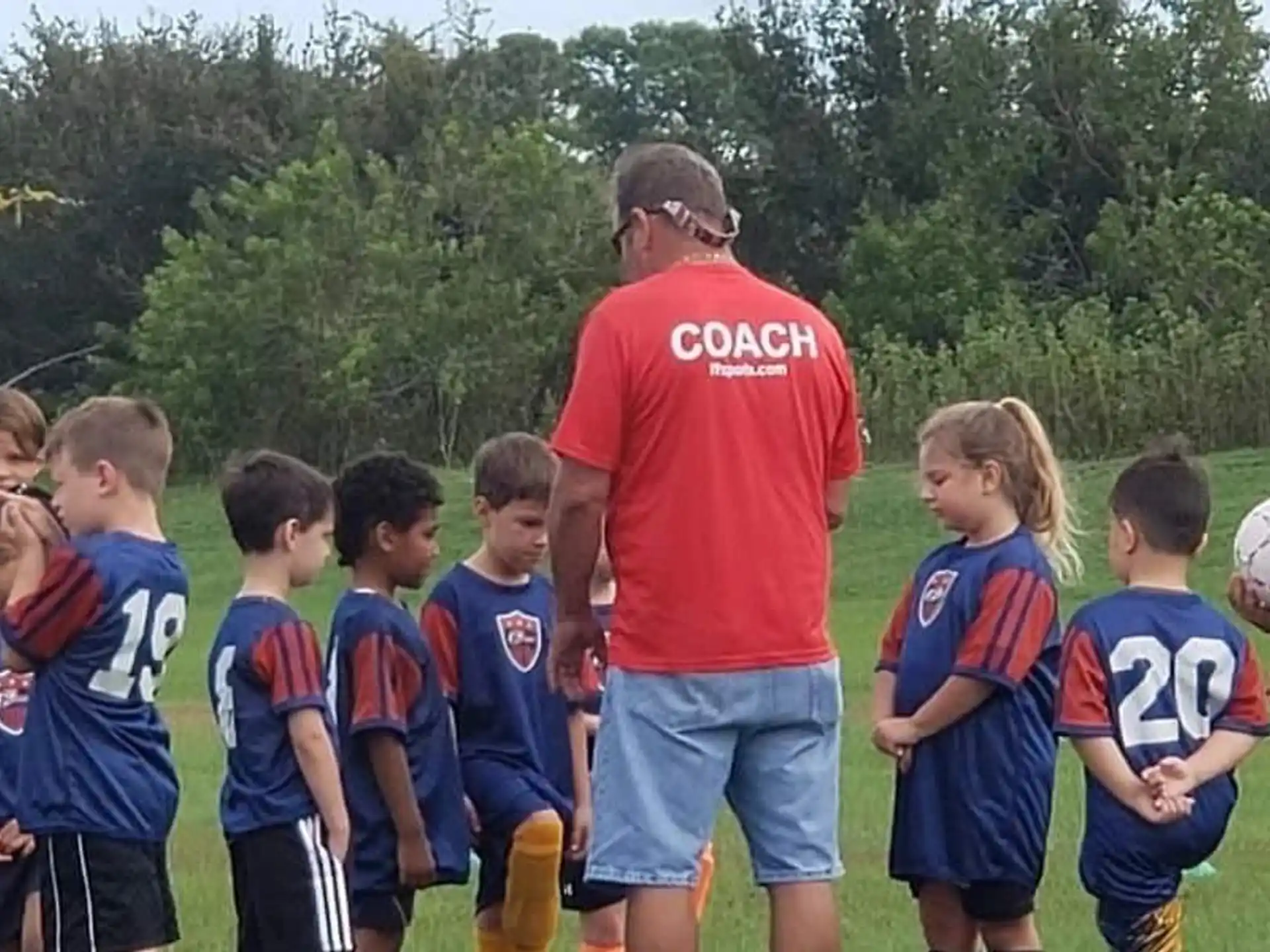 a person talking to a group of kids