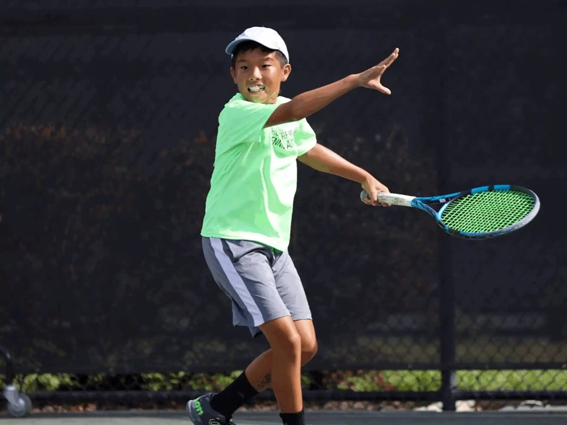 a boy playing tennis