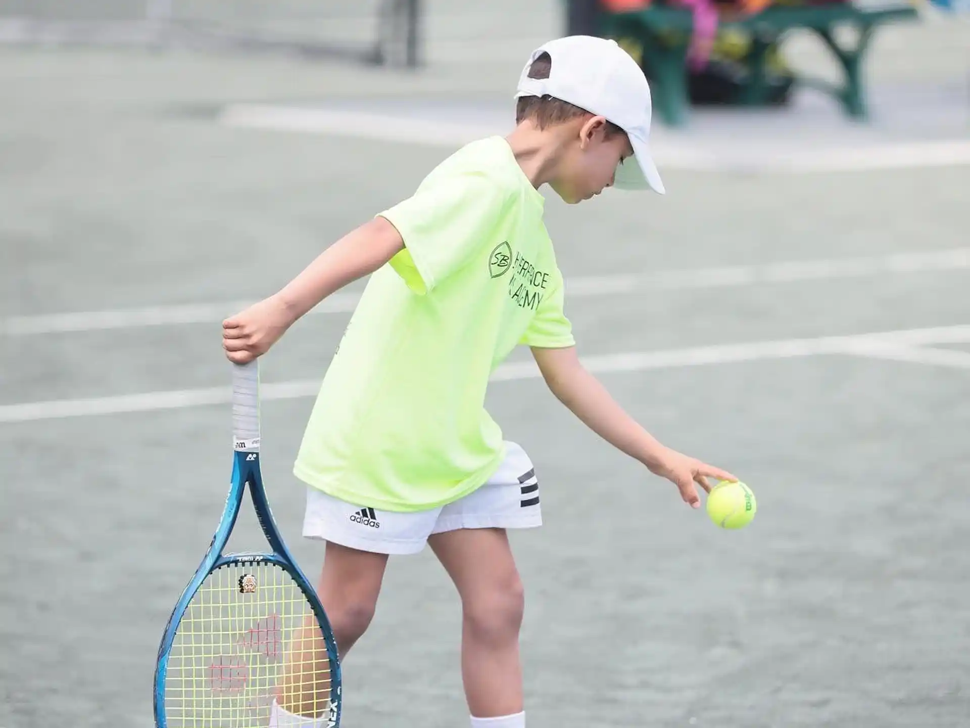 a young boy playing tennis