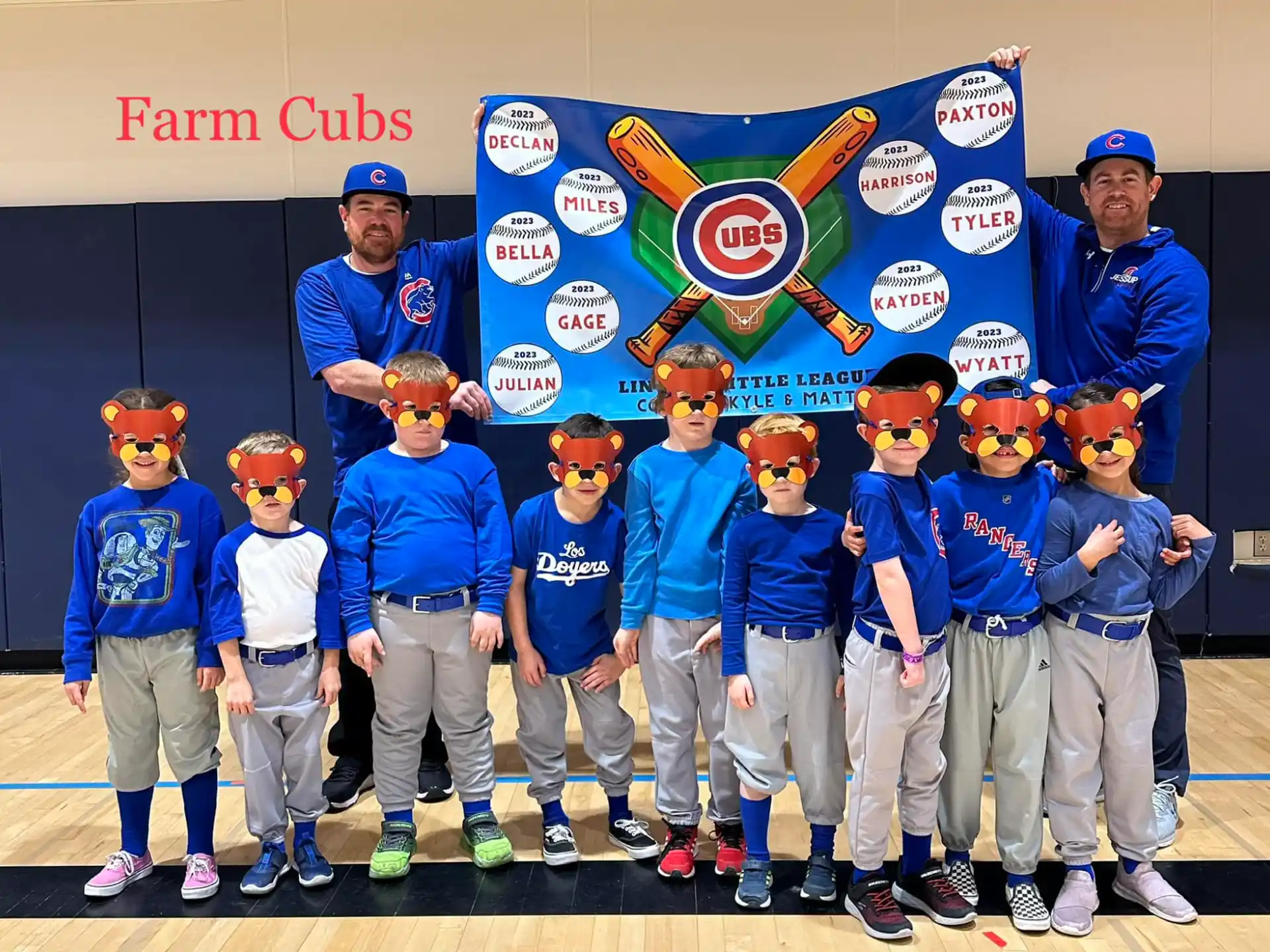 a group of people wearing blue shirts and posing for a photo