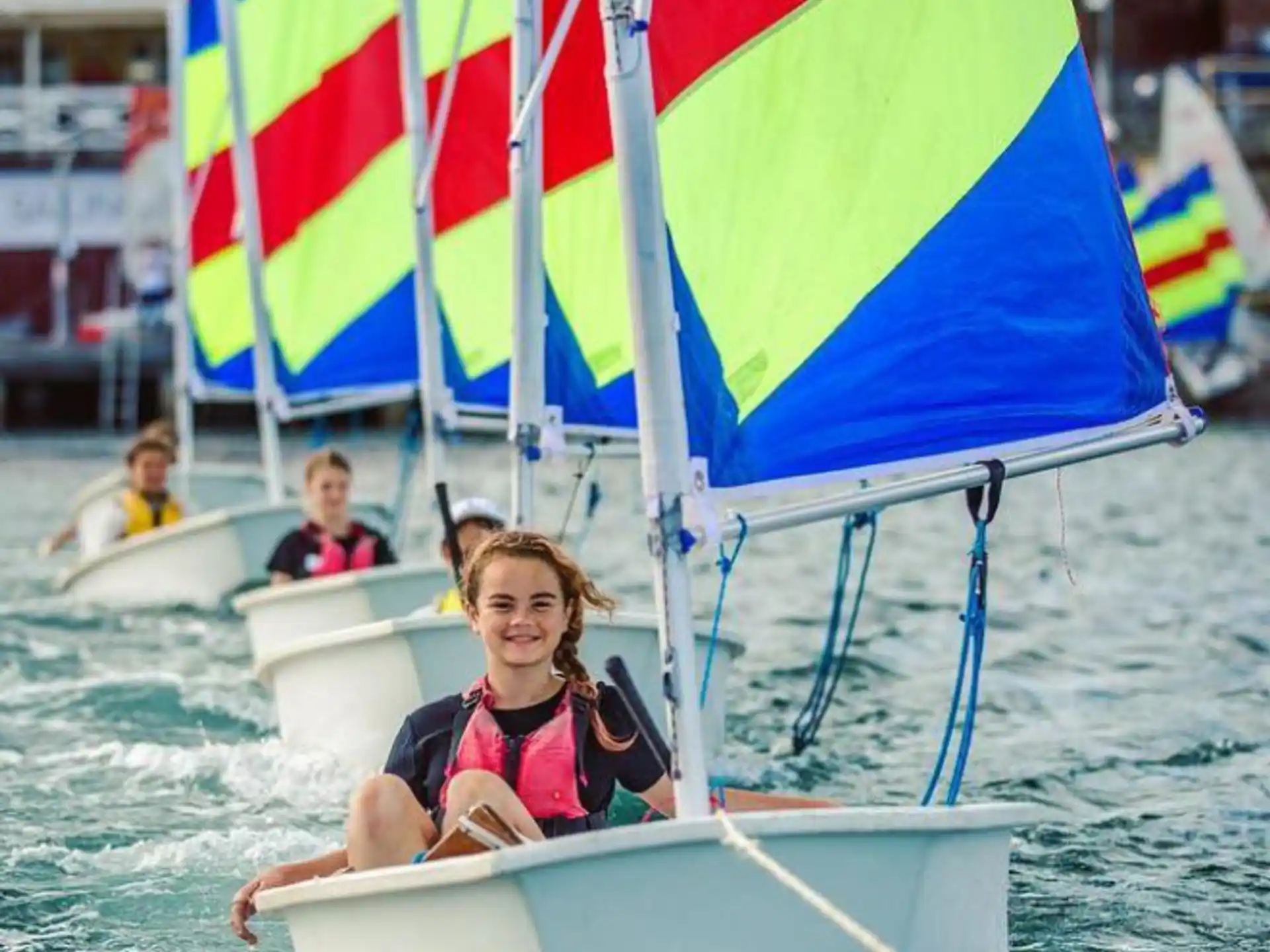a group of people on a boat with flags