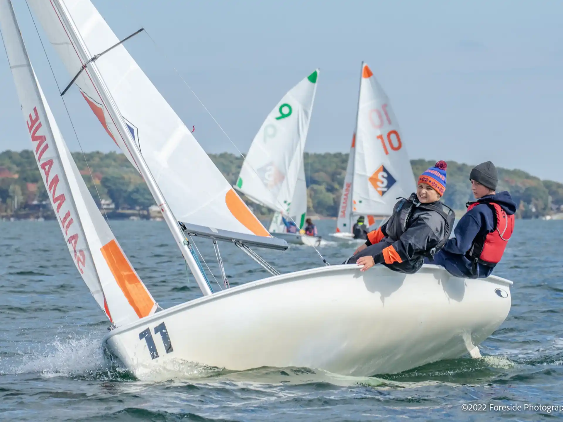 a group of people on a sailboat on the water