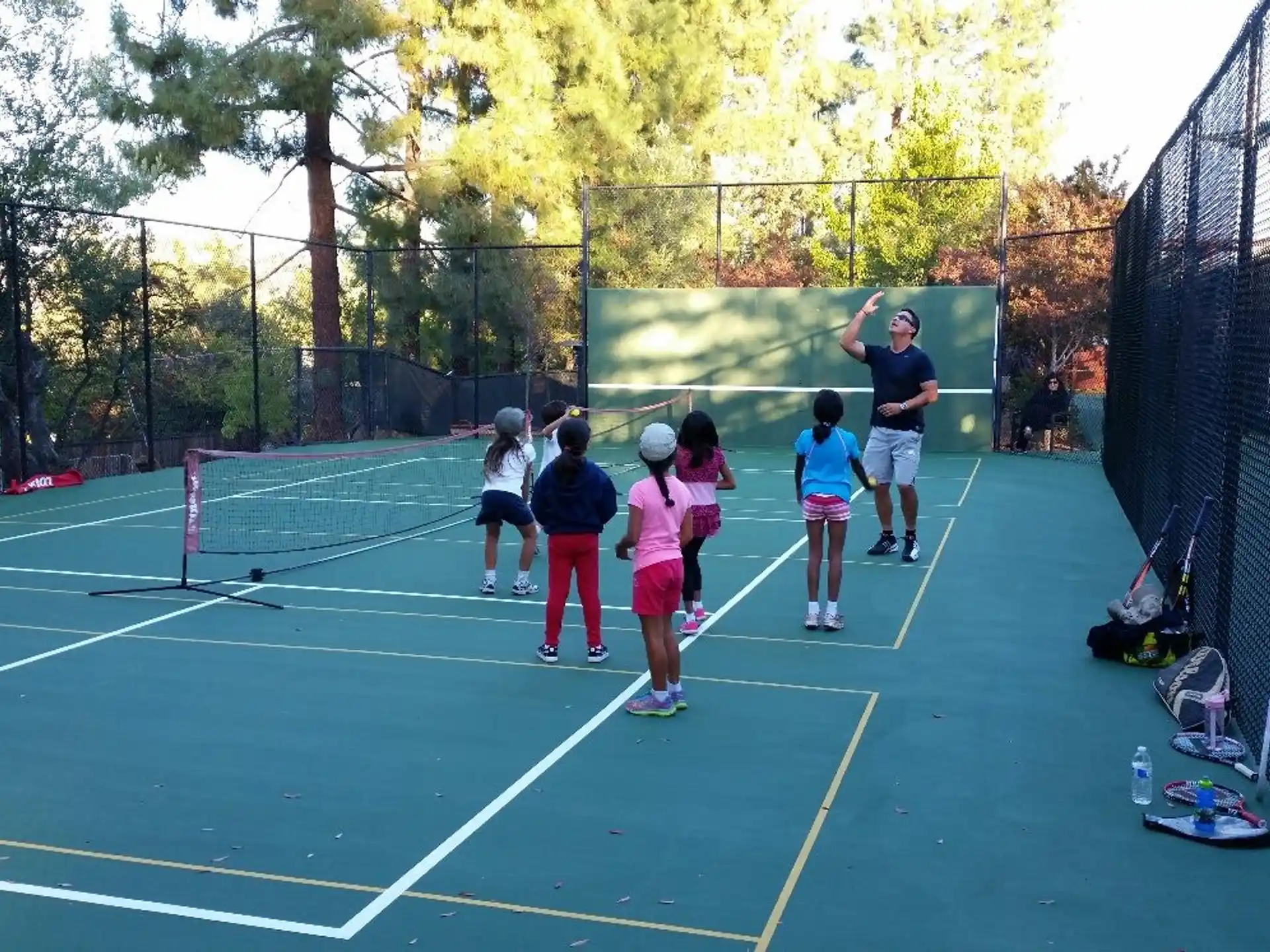 a group of people playing tennis