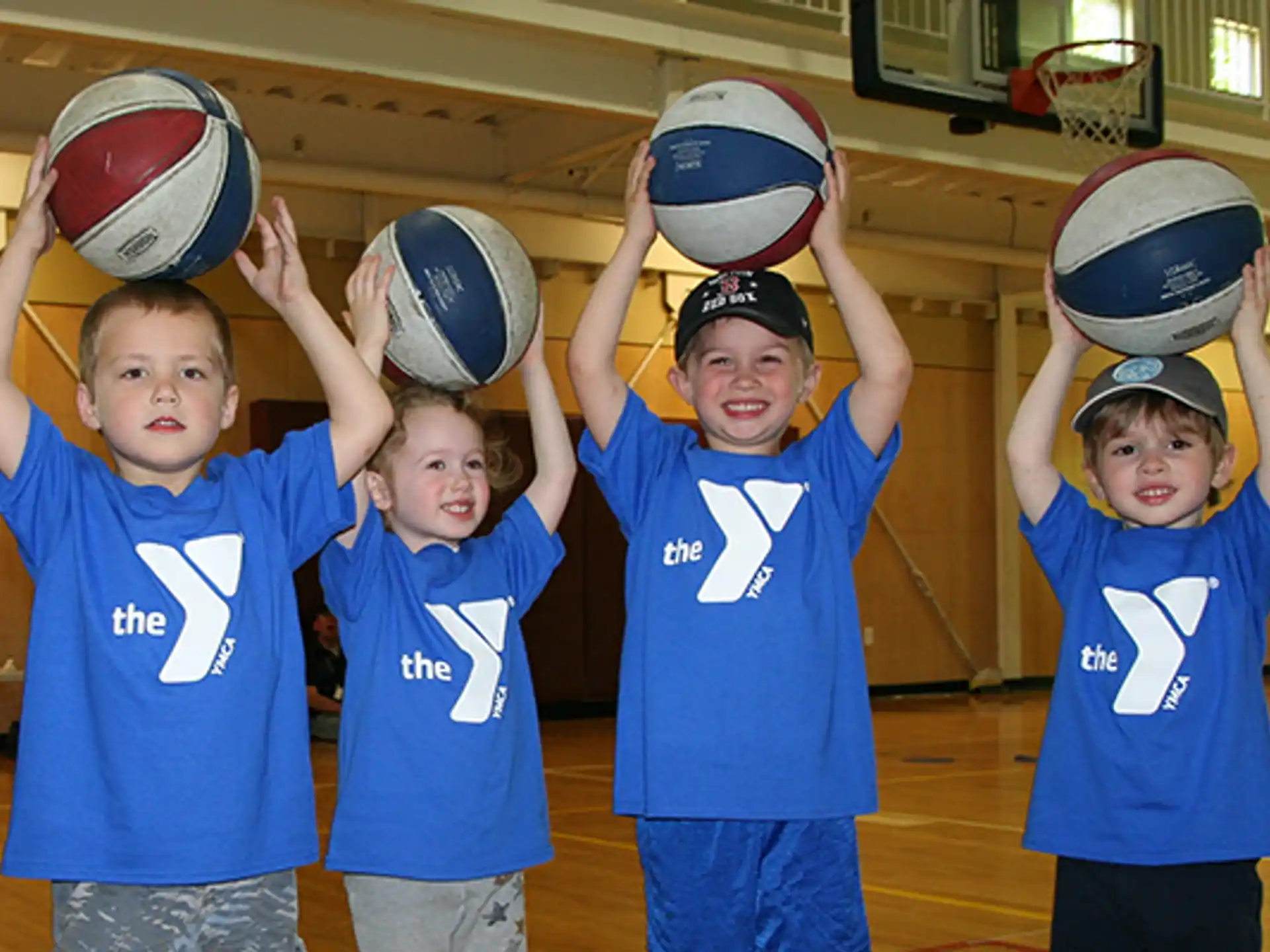 a group of kids holding balls
