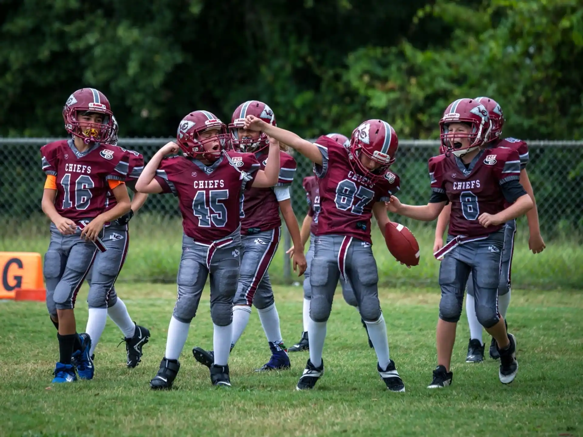 a group of kids playing football