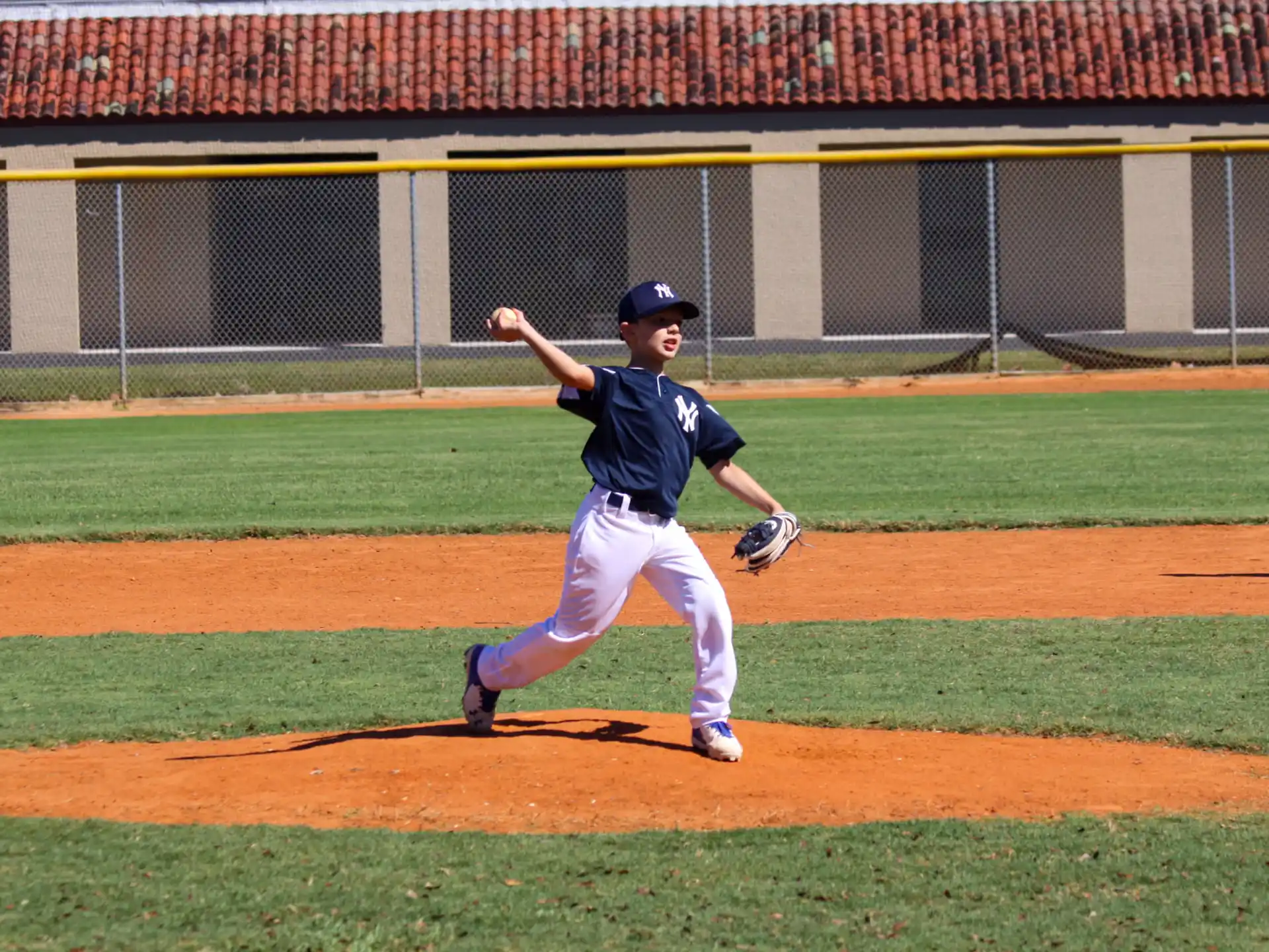 a young boy throwing a baseball