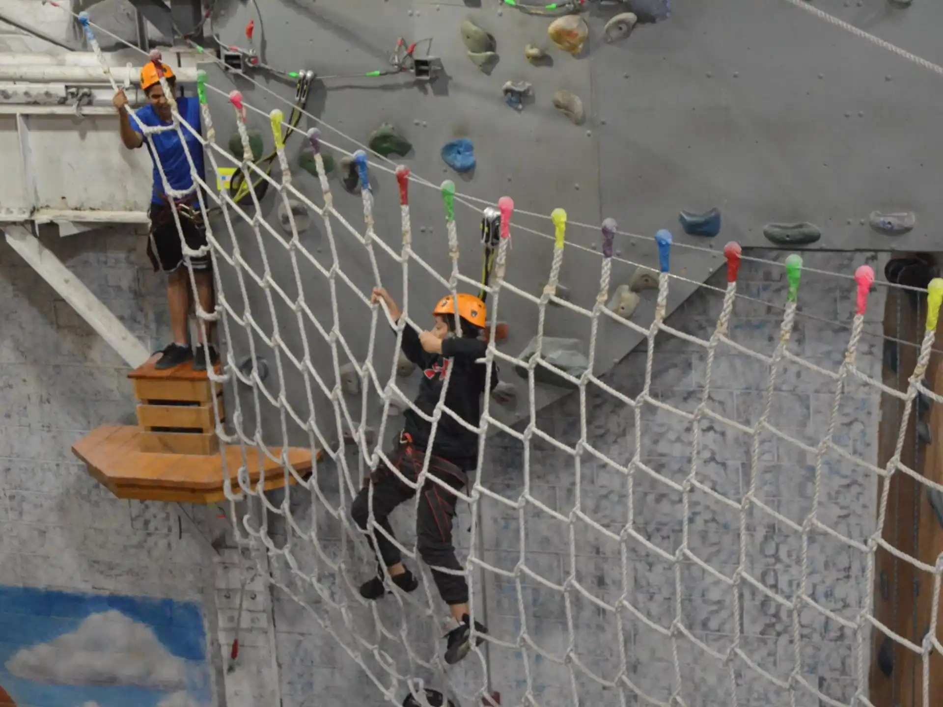 a group of people climbing a rope