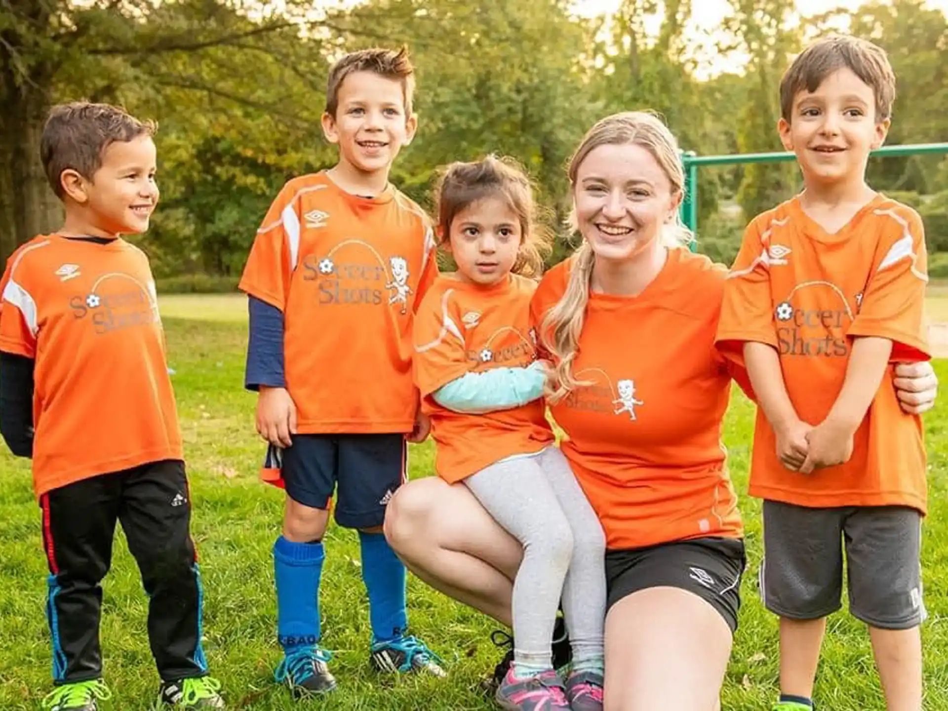 a group of children in orange shirts