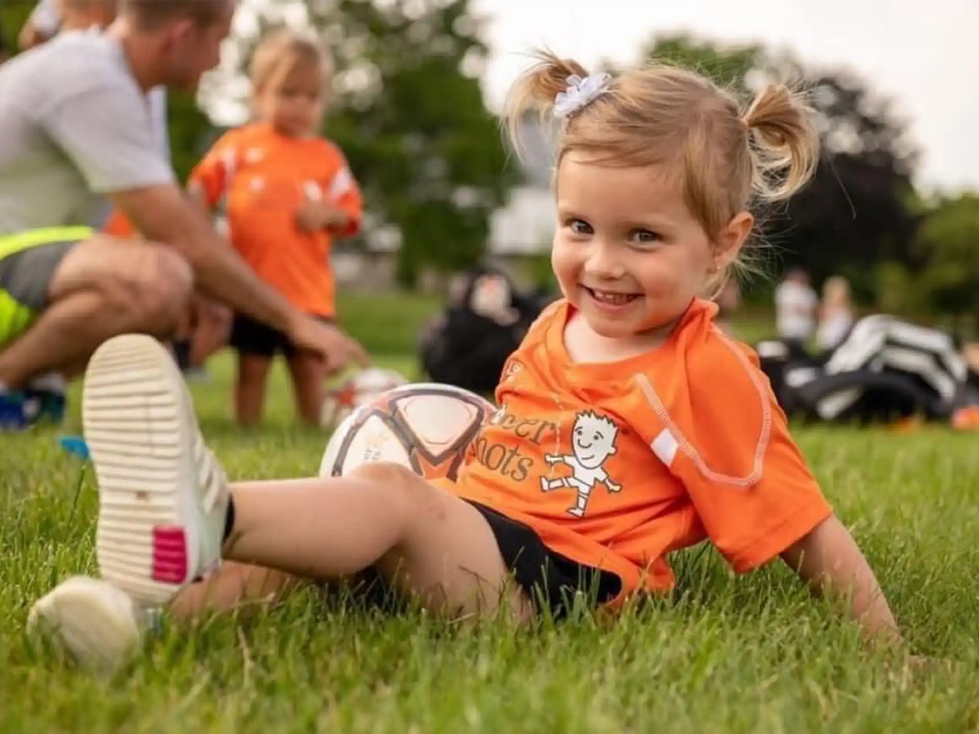 a young girl in a football uniform