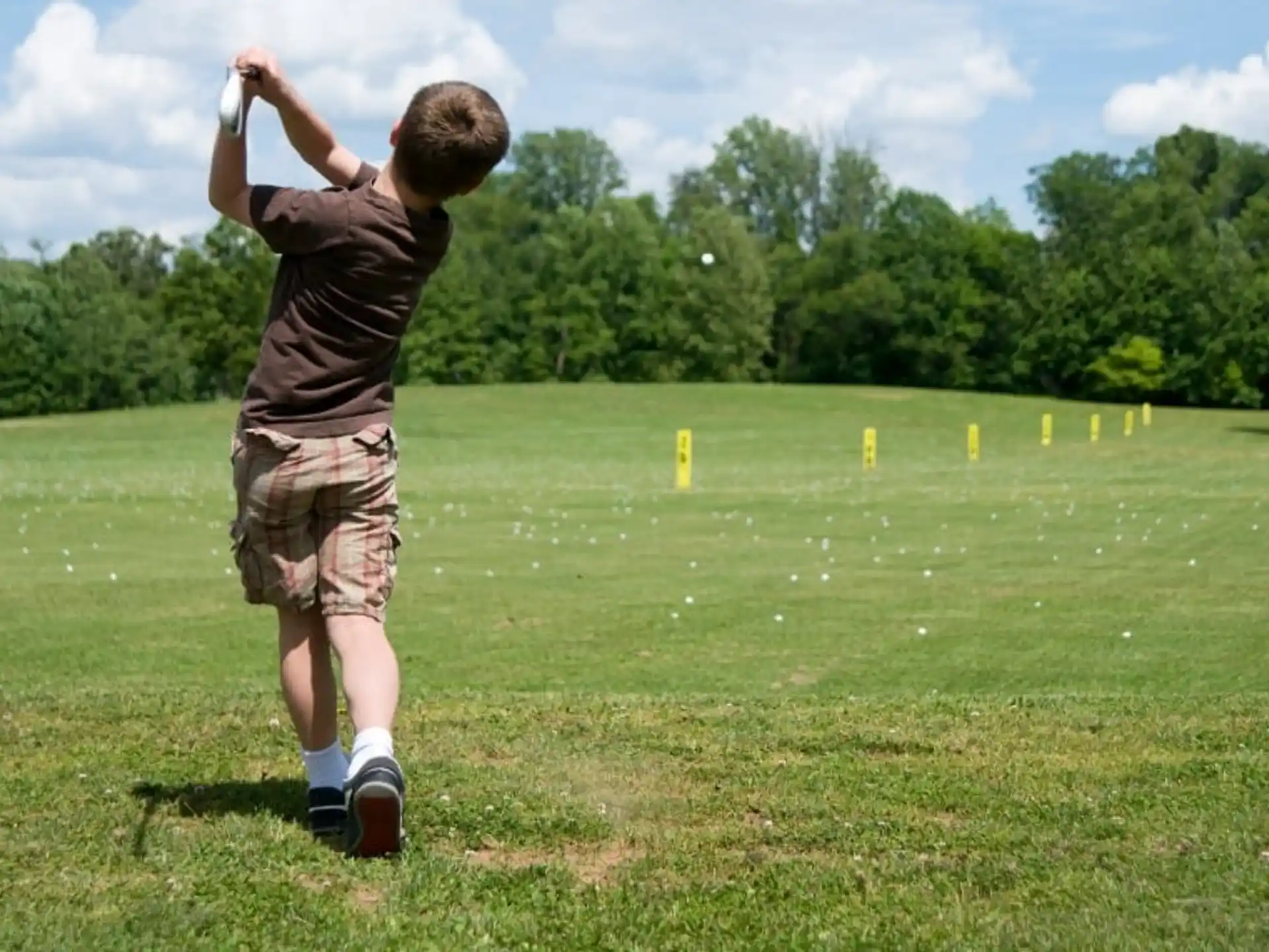 a boy playing golf
