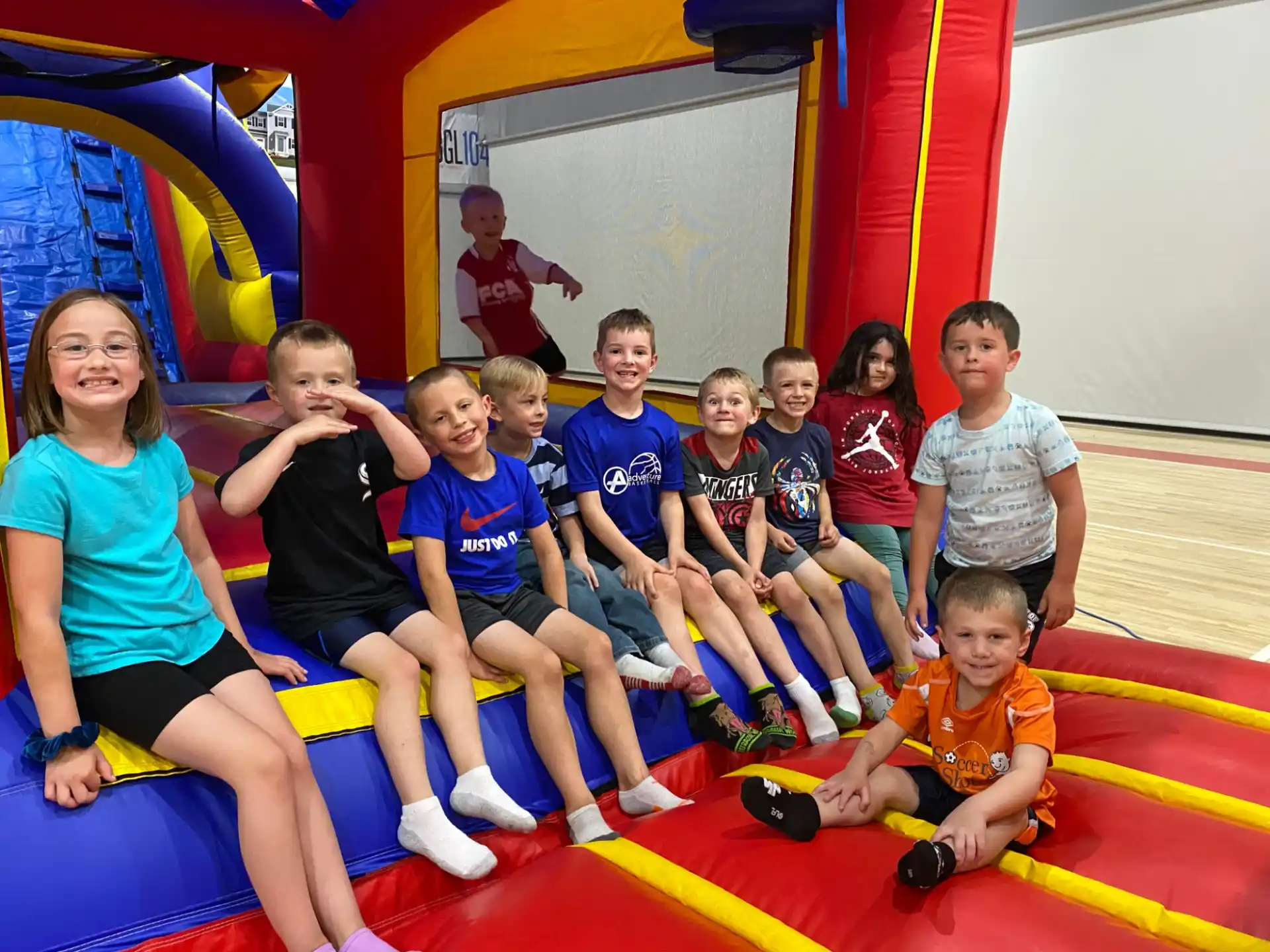 a group of people sitting on a colorful mat