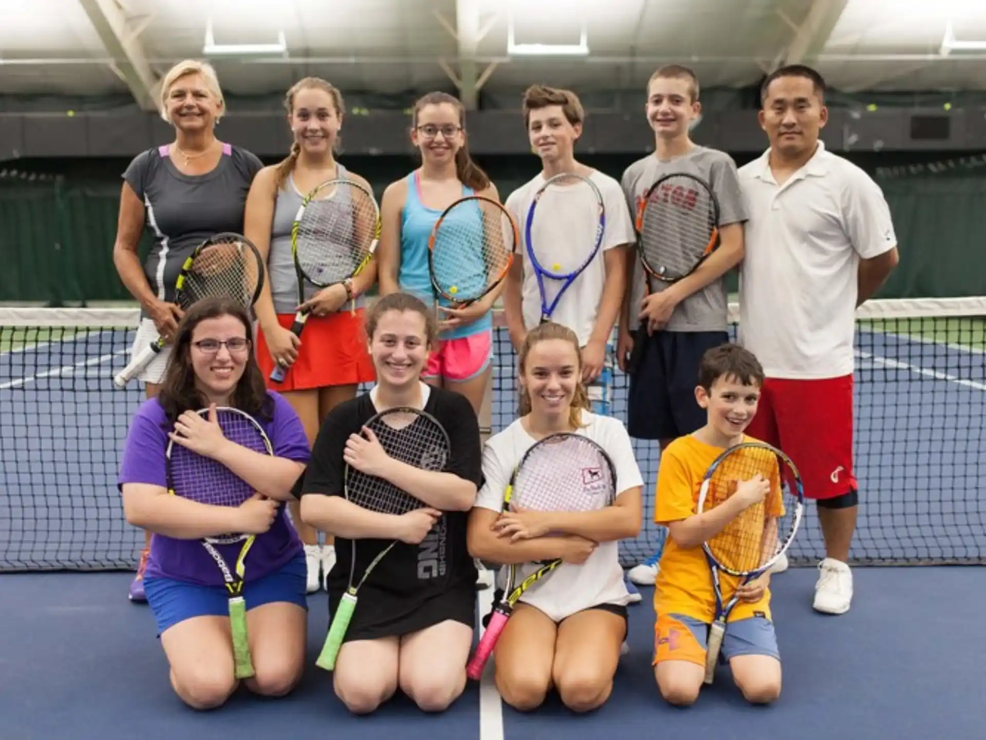 a group of people holding tennis rackets