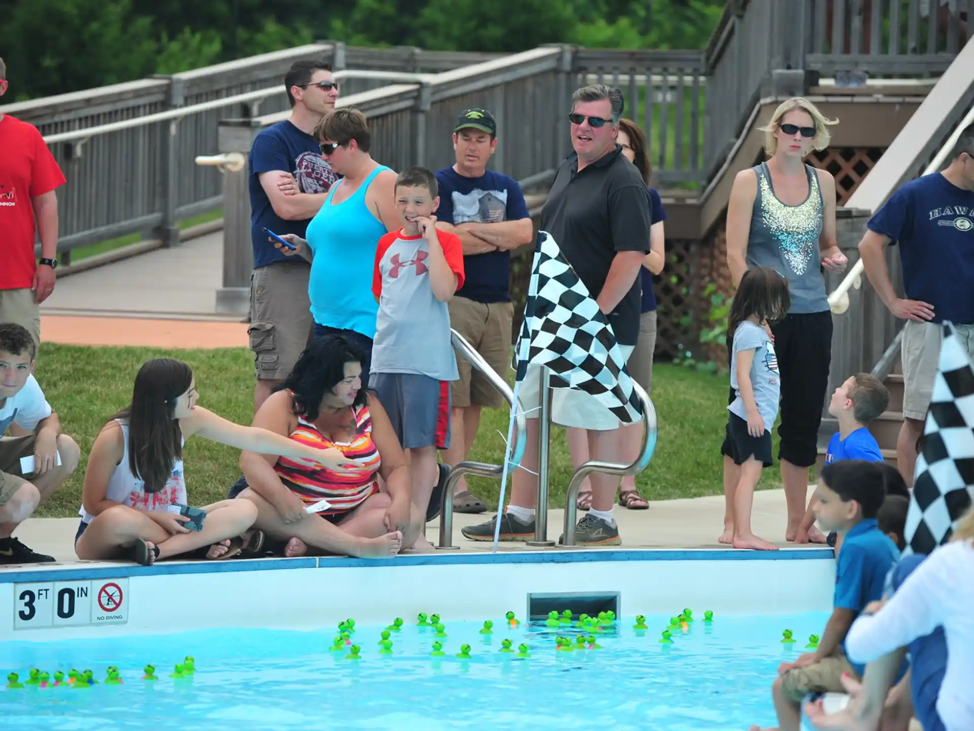 a group of people around a pool