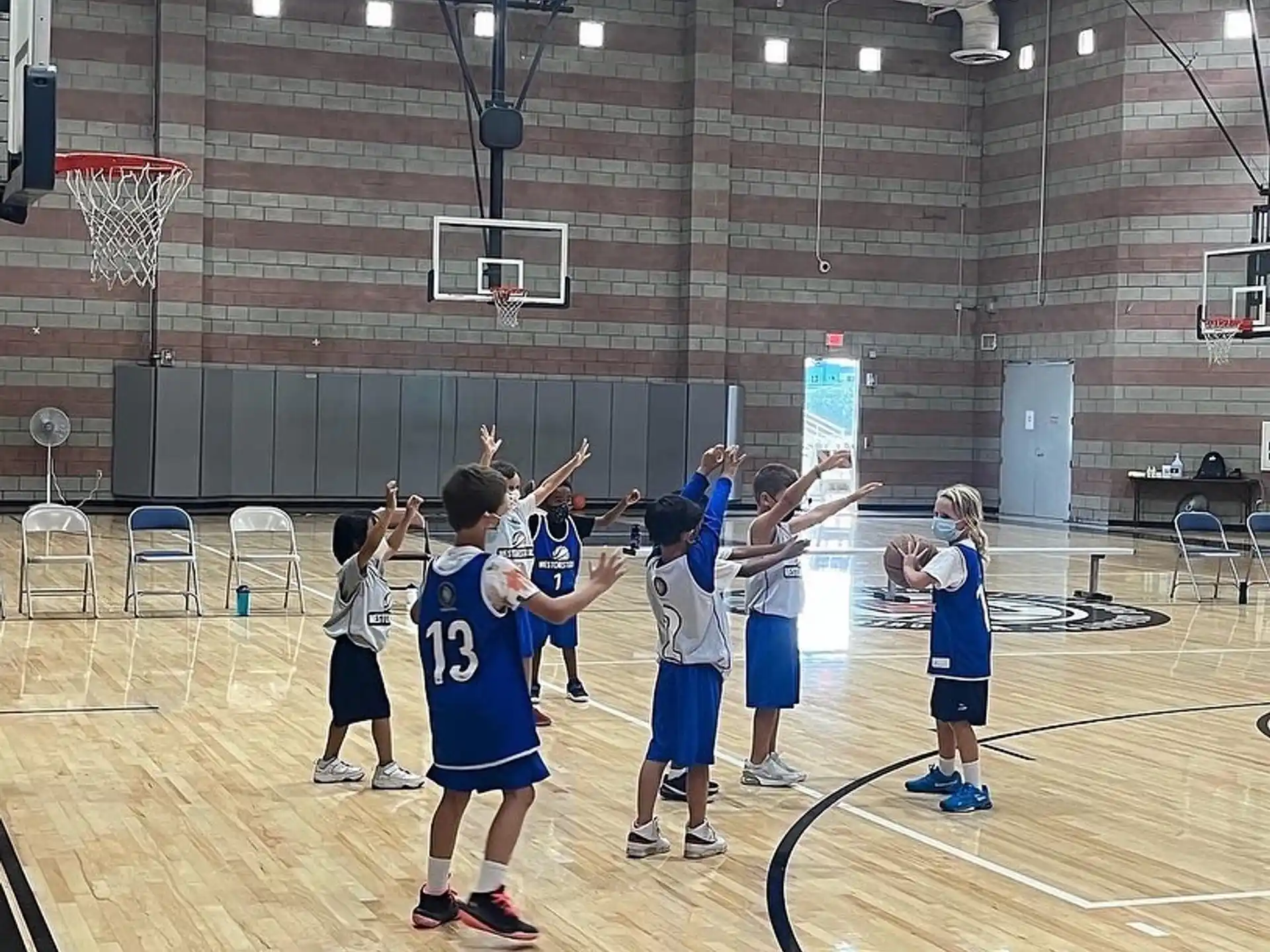 a group of kids playing basketball