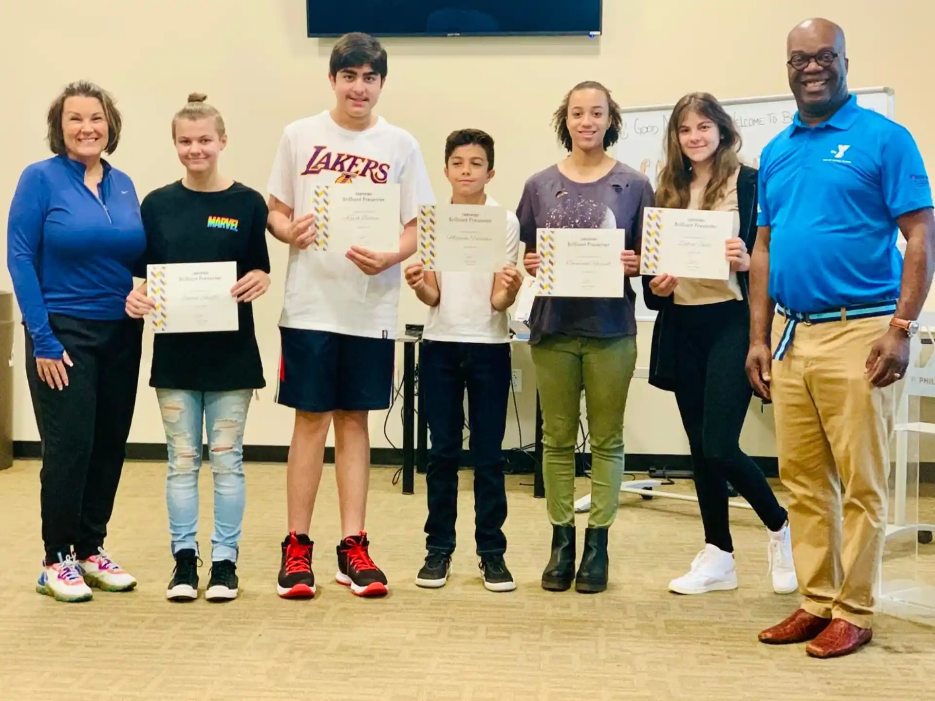 a group of people holding certificates
