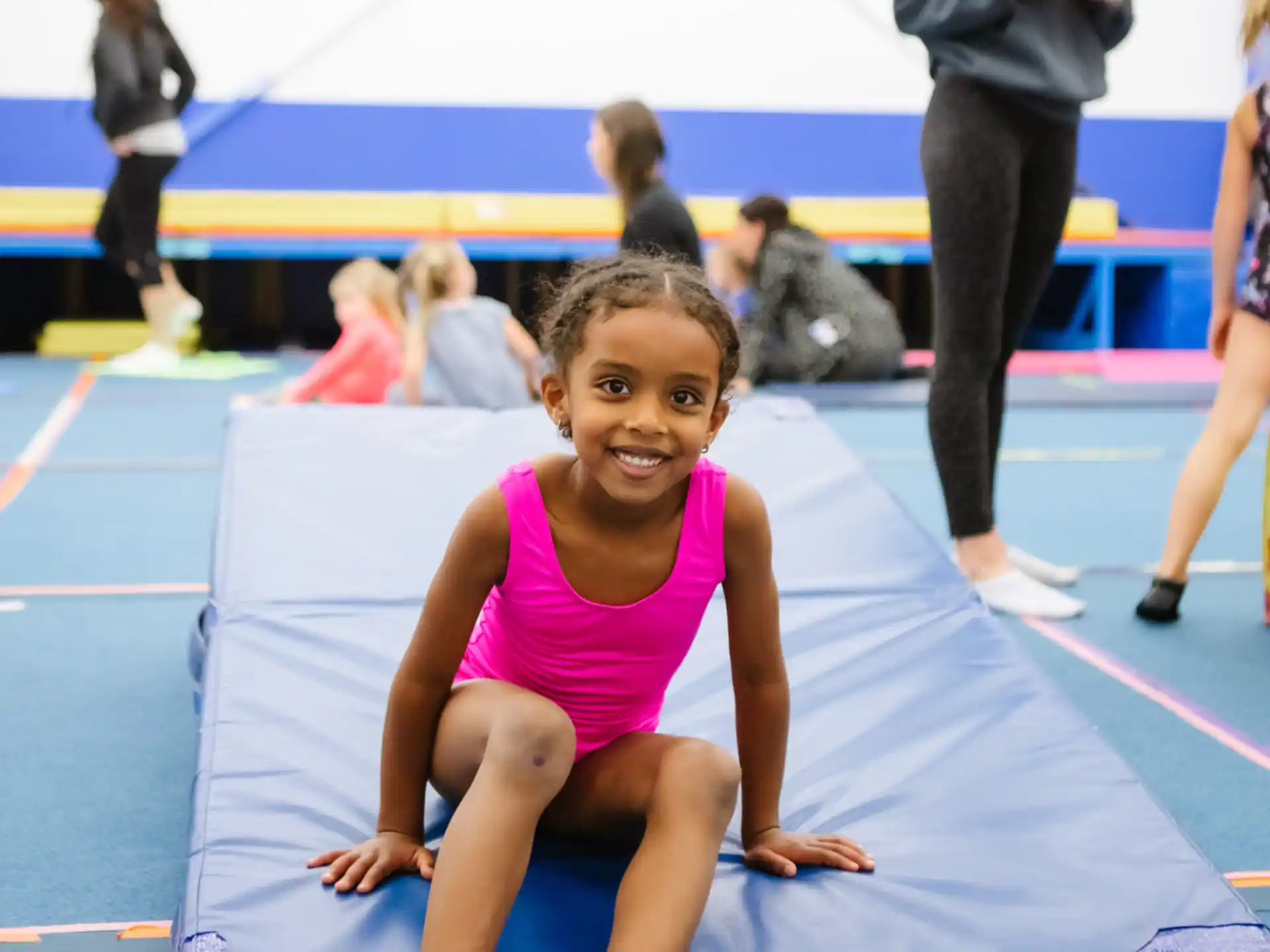 a girl sitting on a mat