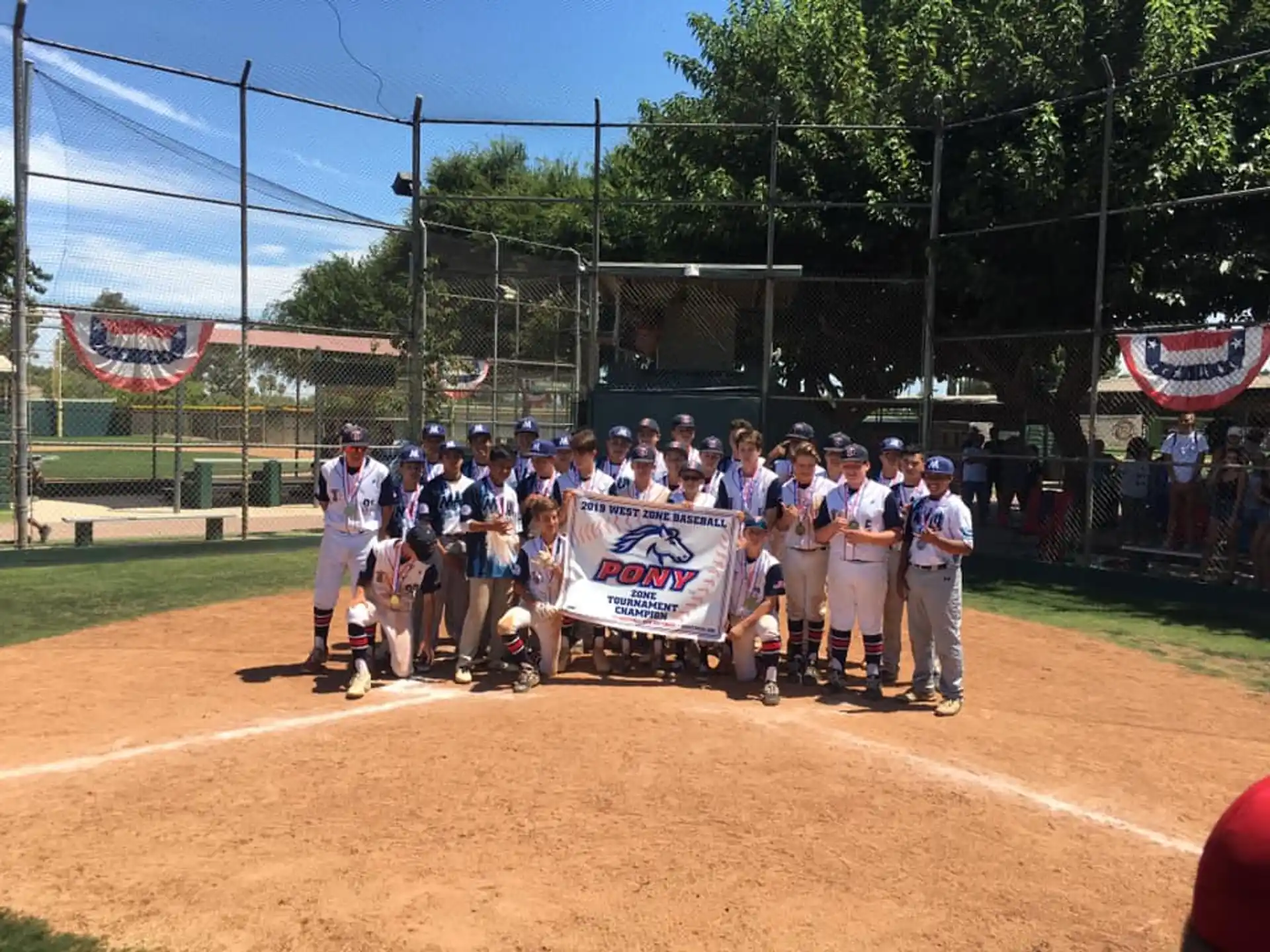 a group of baseball players holding a banner