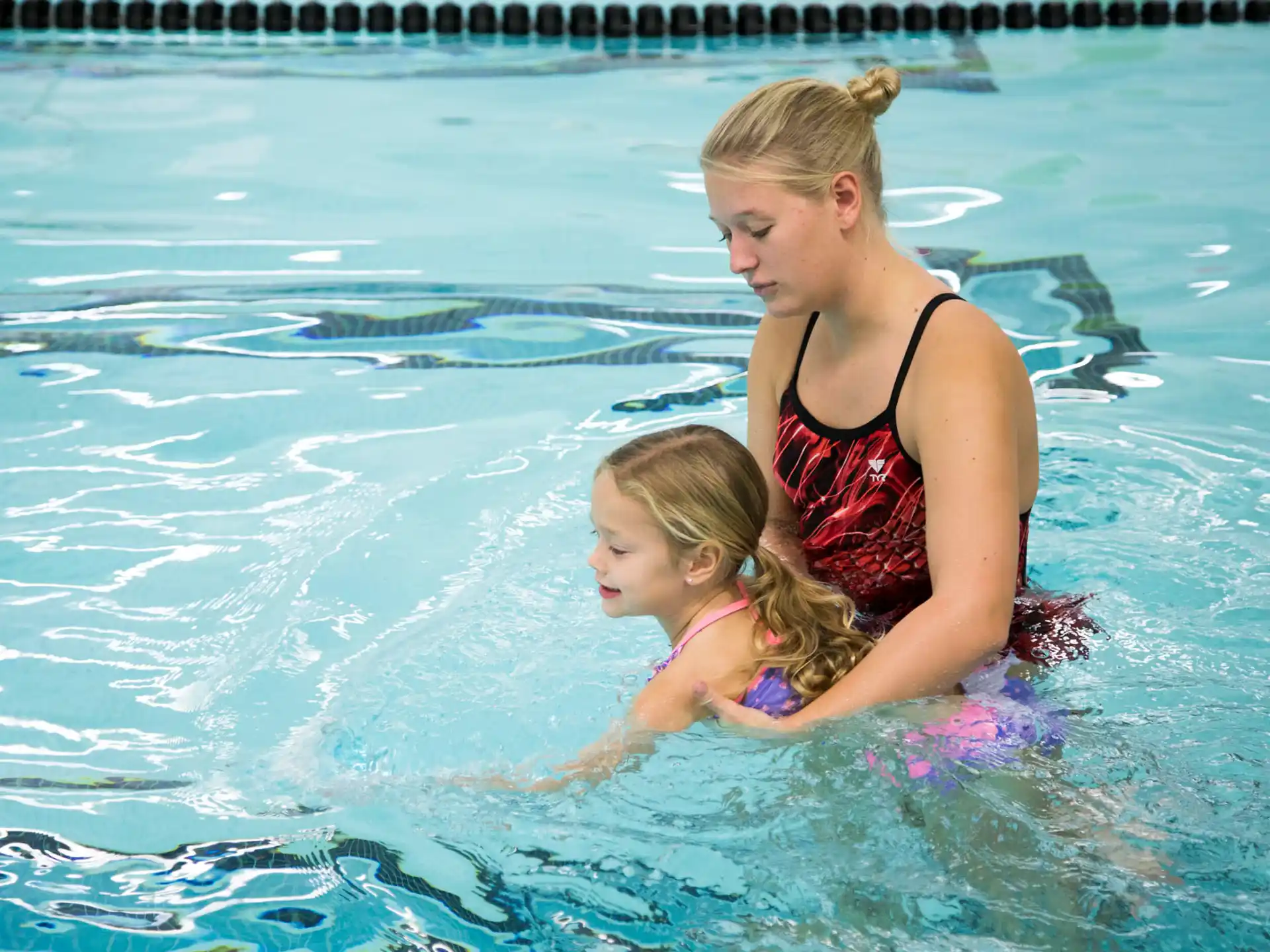 a woman and a child in a pool